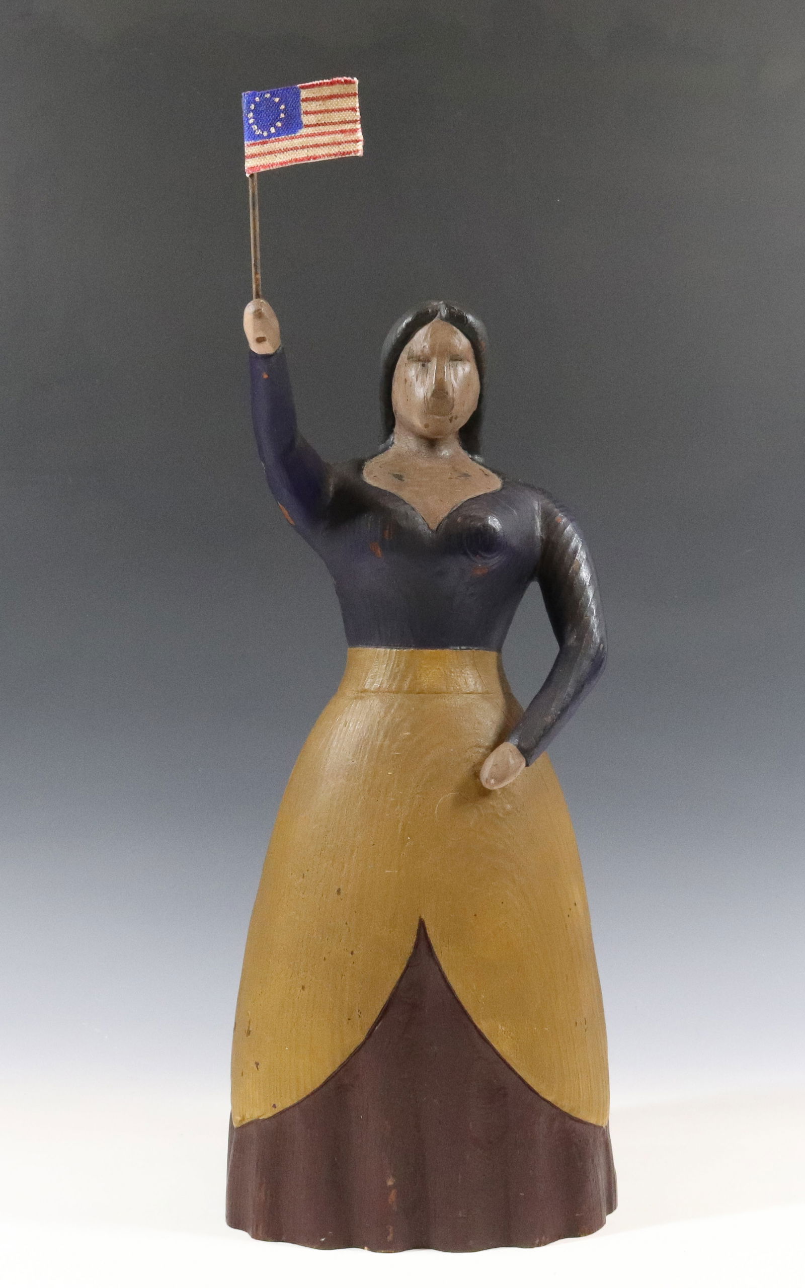 CARVED LADY HOLDING FLAG (1 of 5)