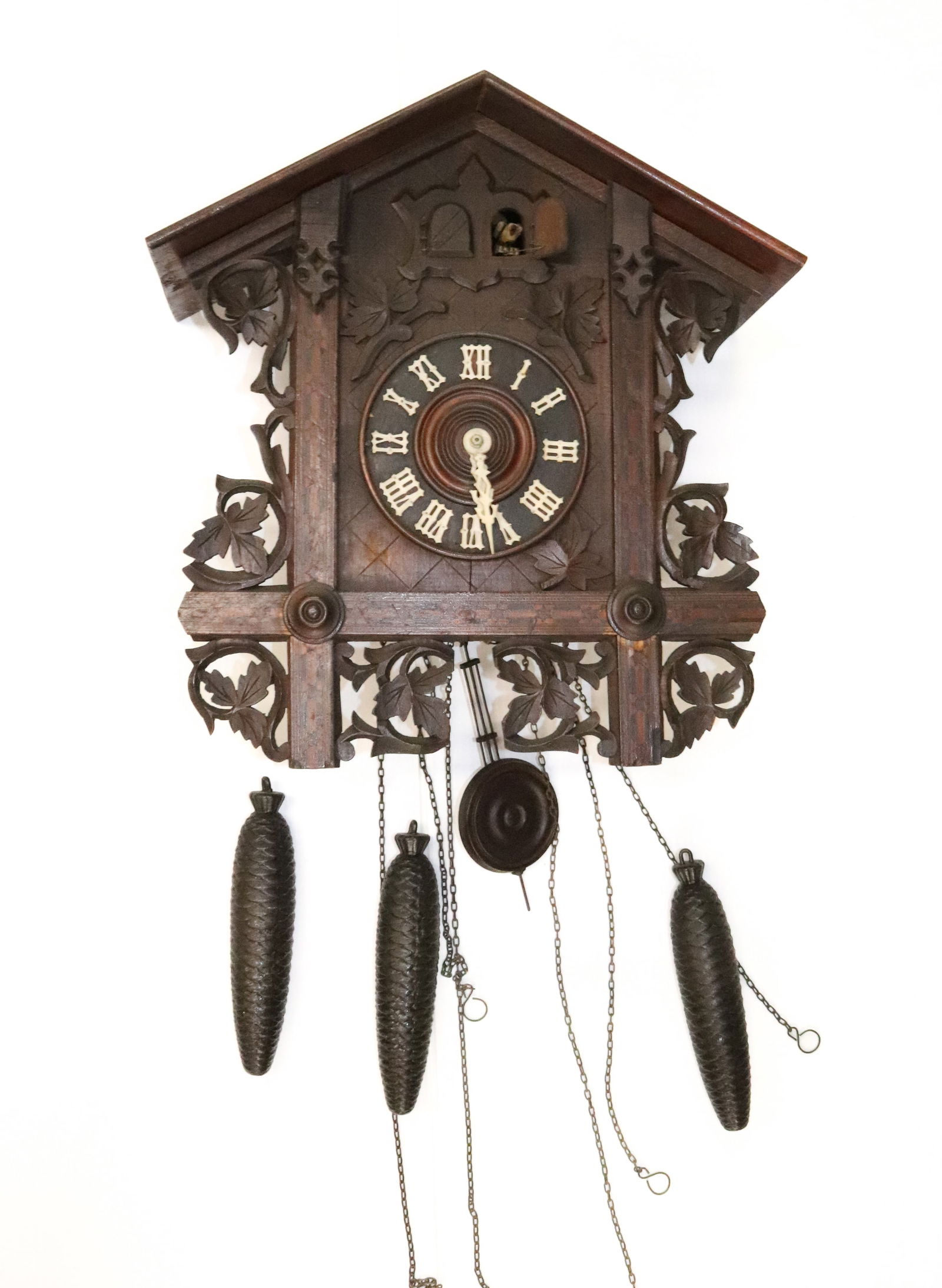 AMERICAN CUCKOO CLOCK: LABELED ON BACK. LEAF TRIM WORK WITH INLAID DECORATION. 16 1/2" X 16 1/2" X 7". PLEASE READ CAREFULLY - Terms for Purchasing and Shipping of Auction Items. Please read carefully before bidding. All pa