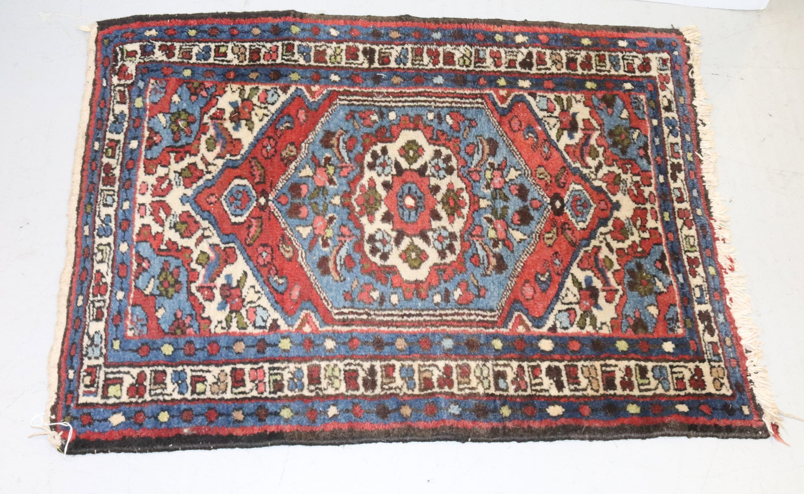 VINTAGE ORIENTAL RUG: BLUE/RED/GREEN/CREAM. TAGGED "IRAN" ON BACK CORNER. 33" X 26". PLEASE READ CAREFULLY - Terms for Purchasing and Shipping of Auction Items. Please read carefully before bidding. All payments for purcha