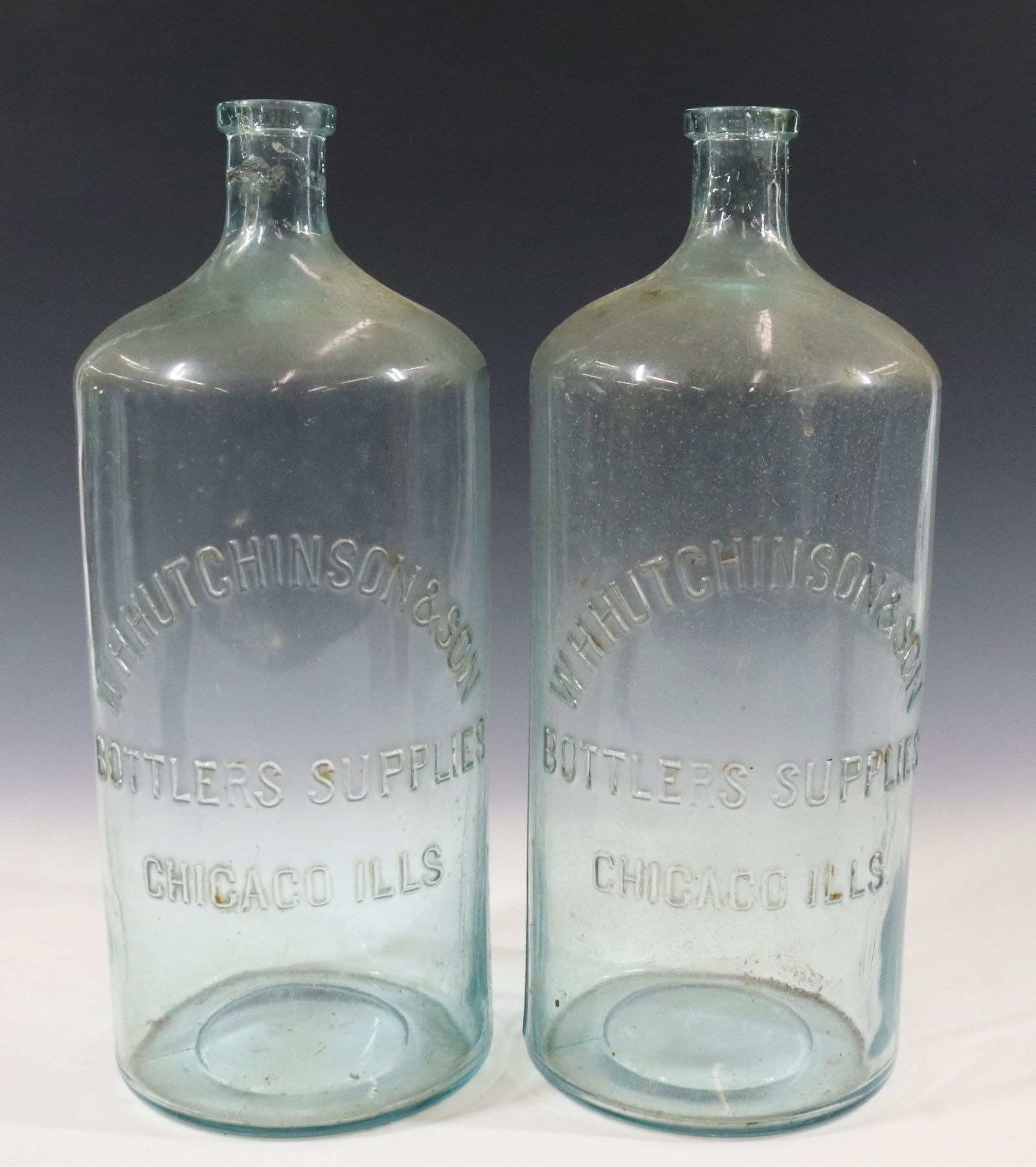 (2) W.H. HUTCHINSON & SON BOTTLES: EMBOSSED "BOTTLERS SUPPLIES, CHICAGO, ILLS". 13 3/4" H. Terms: PLEASE READ CAREFULLY - Terms for Purchasing and Shipping of Auction Items. Please read carefully before bidding. All payments for purcha