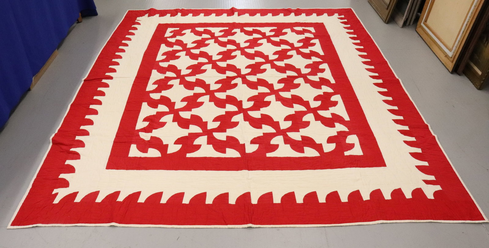 HAND STITCHED RED/WHITE QUILT: LARGE SIZE WITH JAGGED BORDER. 103" X 87". MODERN "HANGING POCKET" ADDED ON EDGE FOR HANGING. Terms: PLEASE READ CAREFULLY - Terms for Purchasing and Shipping of Auction Items. Please read carefully b