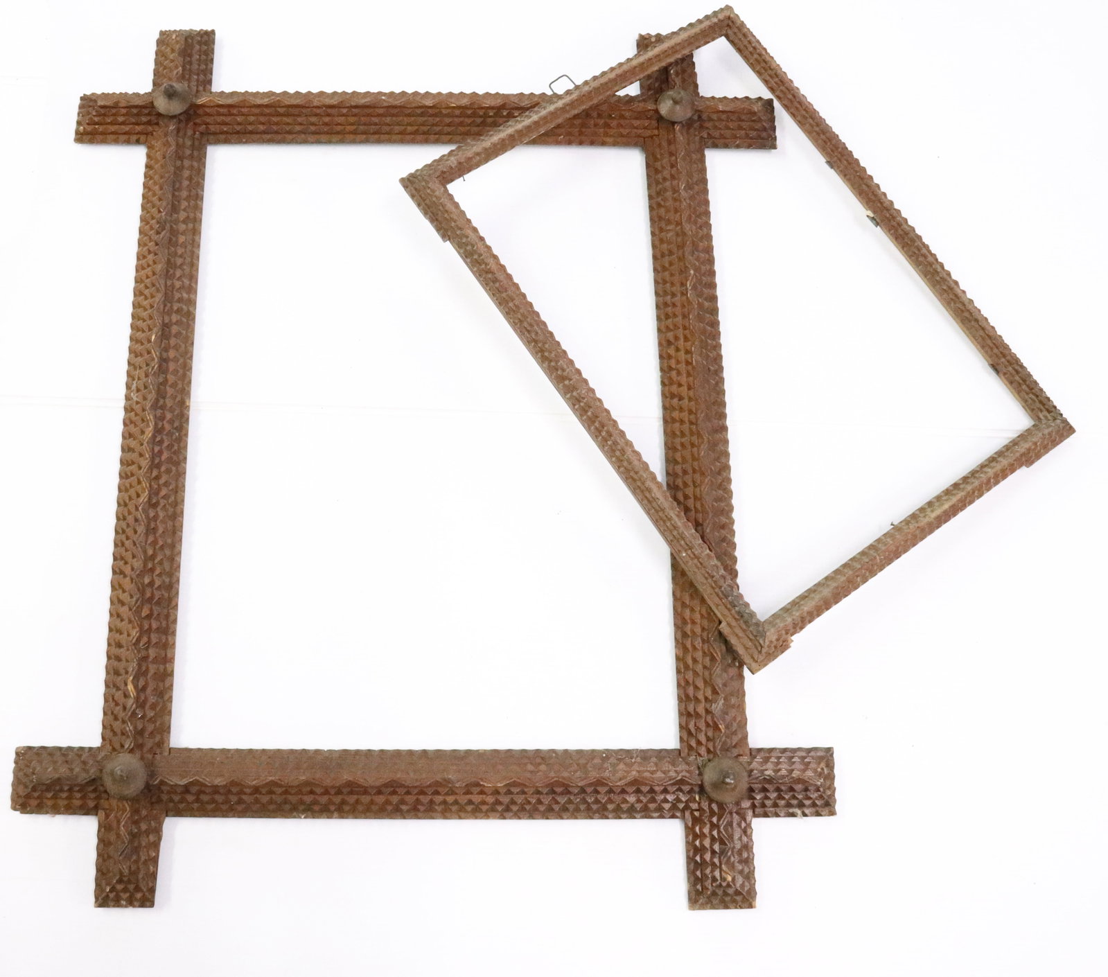 (2) TRAMP ART CARVED FRAMES: CHIP CARVED WITH DARK SURFACES, 28" X 34 1/2" OVERALL AND 18" X 23 3/4" - 22 1/4" X 16 1/2" OVERALL AND 19 1/2" X 14 1/4" INTERIOR