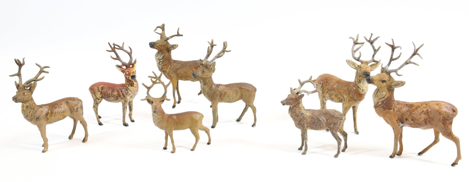 (8) PAINTED METAL DEER: LARGEST 4 3/4" X 3 3/4". TWO MRKD. GERMANY ON BELLY.