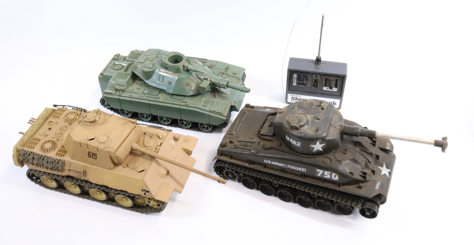 (3) BATTERY OP TANKS: HASBRO, NIKO AND UNMARKED. INCLUDES SHERMAN TANK CONTROLLER. LARGEST 11" L.