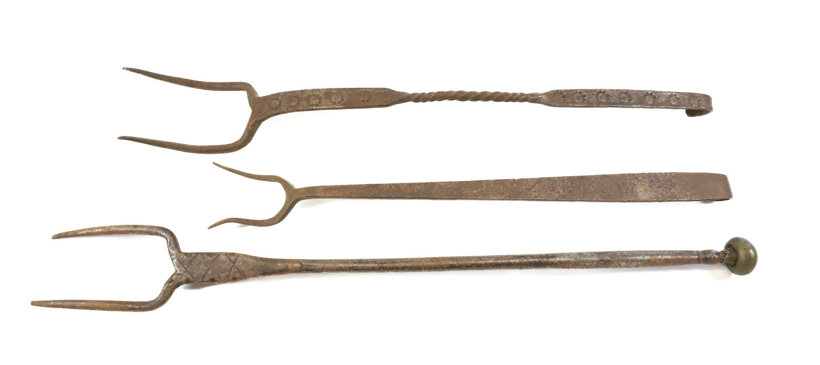 WROUGHT IRON BUTCHER FORKS: THREE INCLUDING ONE WITH TWISTED HANDLE AND STAMPED DECORATION. LARGEST HAS BRASS CAP ON END. 16 1/2" TO 22" L. Terms: PLEASE READ CAREFULLY - Terms for Purchasing and Shipping of Auction Items. Pleas
