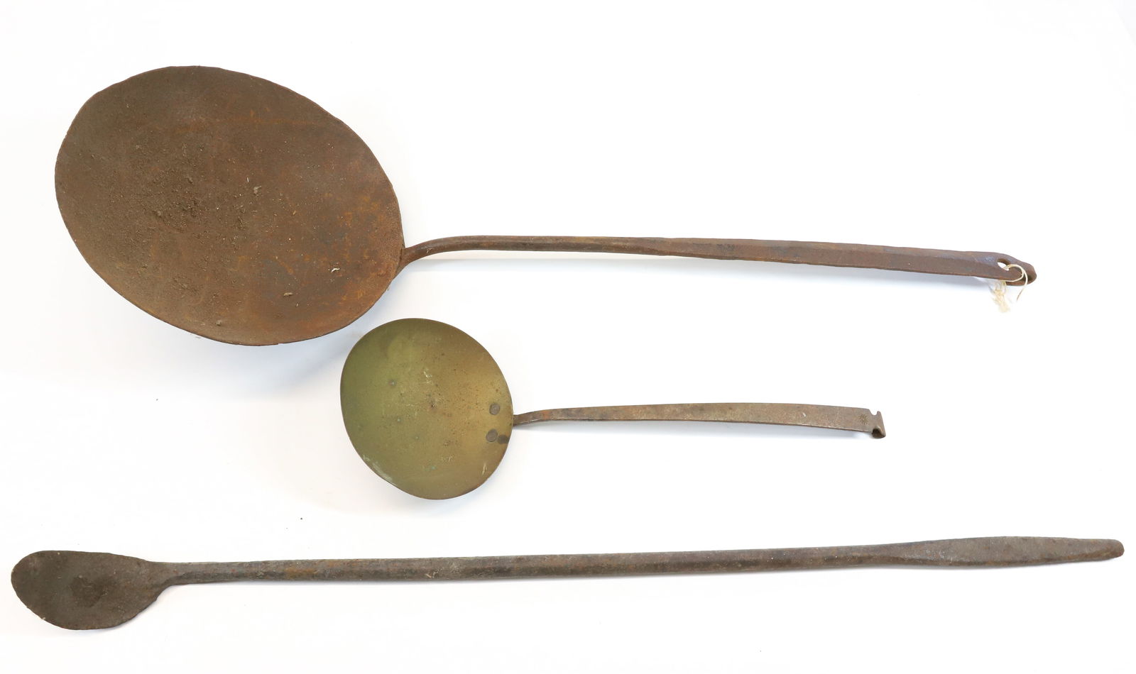 LOT OF WROUGHT IRON UTENSILS: INCLUDING LARGE WROUGHT LADLE, BRASS BOWLED SPOON WITH SUNBURST MRK. ON HANDLE AND WROUGHT SCRAPER 25" L. Terms: PLEASE READ CAREFULLY - Terms for Purchasing and Shipping of Auction Items. Please read