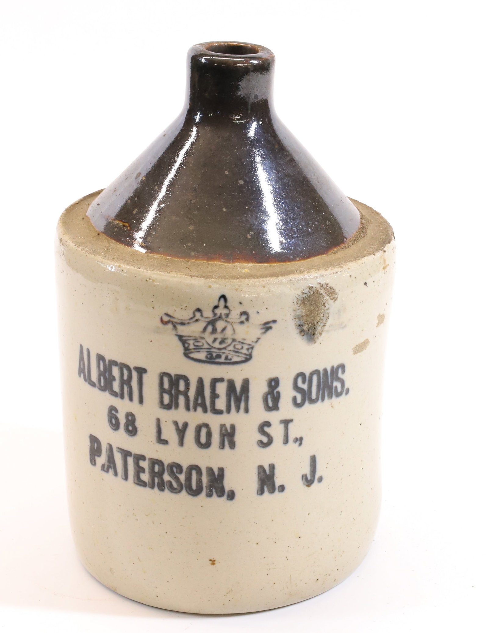 STENCILED PATERSON, NJ ADVERTISING JUG: ALBERT BRAEM & SONS, 68 LYON ST., PATERSON, NJ. 9" H. Terms: PLEASE READ CAREFULLY - Terms for Purchasing and Shipping of Auction Items. Please read carefully before bidding. All payments for purchase