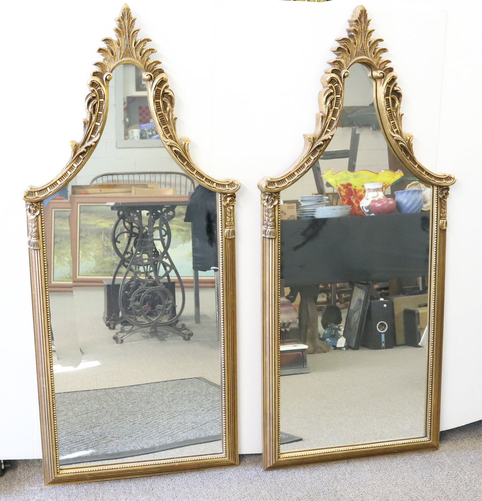 PAIR OF ORNATE GILT MIRRORS: UNUSUAL SHAPE WITH TASSEL ORNAMENTATION. 48 1/2" X 21 1/2". Terms: PLEASE READ CAREFULLY - Terms for Purchasing and Shipping of Auction Items. Please read carefully before bidding. All payments for pu