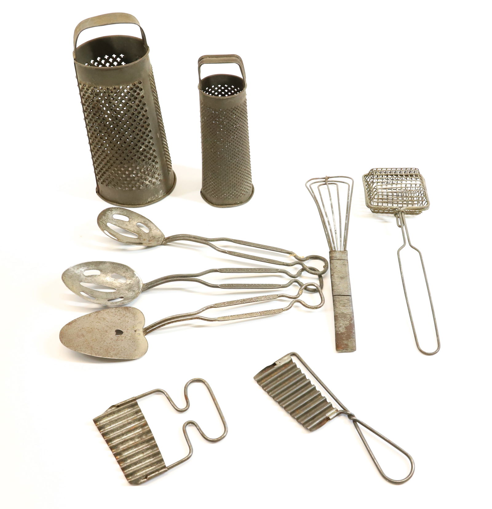 LOT OF KITCHEN TINWARE: INCLUDING: TWO UNUSUAL ROUND GRATERS, WHISK, ADVERTISING SPOONS ( SAUER'S VANILLA AND RYAN FOLEY CO. COAL, SOAP SAVER AND MORE. Terms: PLEASE READ CAREFULLY - Terms for Purchasing and Shipping of Auct