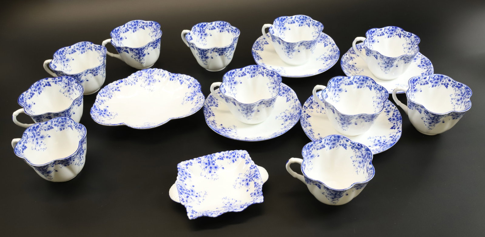 SET OF SHELLEY FINE BONE CHINA: (11) CUPS, (4) SAUCERS AND (2) SHALLOW PLATES 5" AND 6 3/4" L. DAINTY BLUE PATTERN. Terms: PLEASE READ CAREFULLY - Terms for Purchasing and Shipping of Auction Items. Please read carefully before bidd