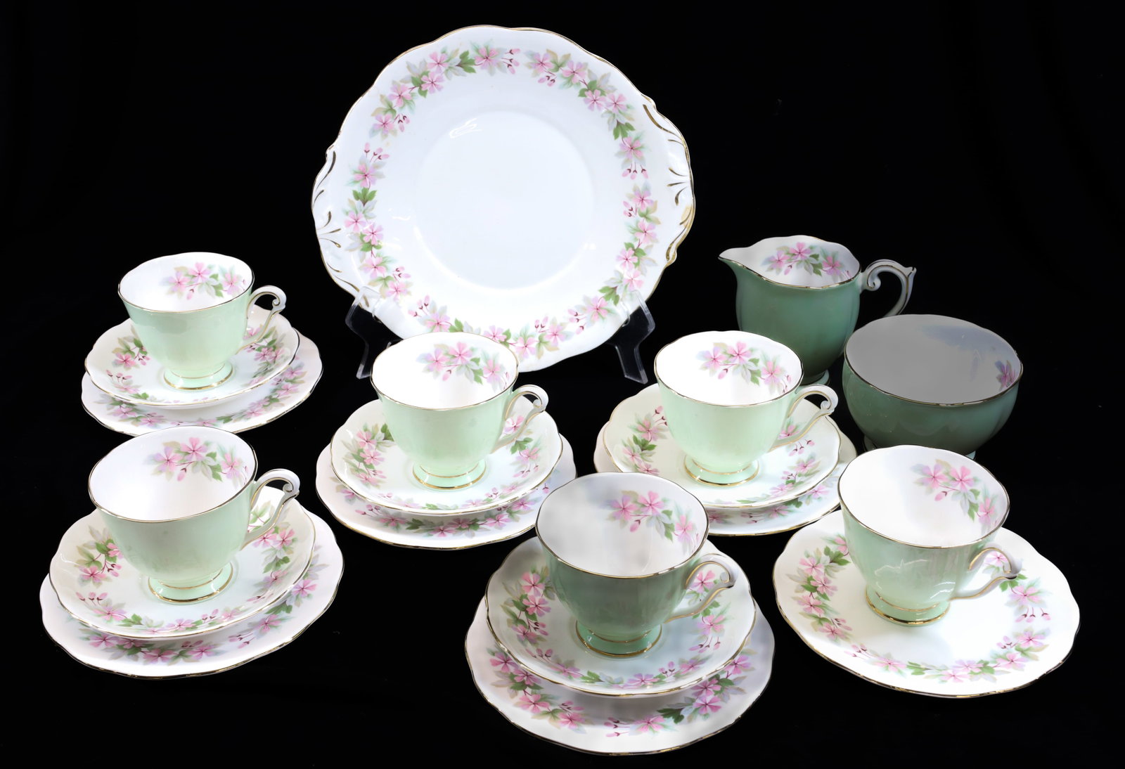 SET OF ENGLISH BONE CHINA: GENEVIEVE QUEEN ANNE PATTERN. TAB HANDLED PLATE 10 1/4" D. SIX PLATES 6 1/2" D. SIX CUPS/FIVE SAUCERS WITH CREAMER AND WASTE BOWL. Terms: PLEASE READ CAREFULLY - Terms for Purchasing and Shipping of A
