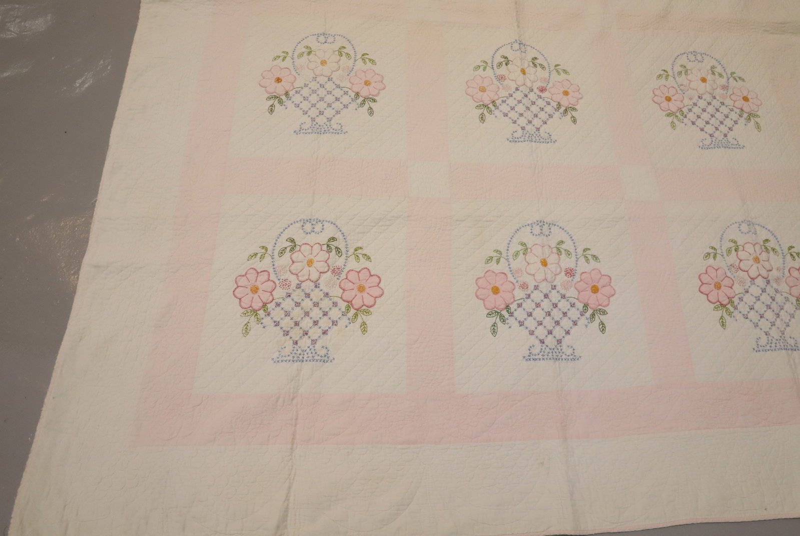 HAND STITCHED FLORAL QUILT: PALE PINK/WHITE FLOWERS IN BASKETS. 96" X 74". Terms: PLEASE READ CAREFULLY - Terms for Purchasing and Shipping of Auction Items. Please read carefully before bidding. All payments for purchases will 
