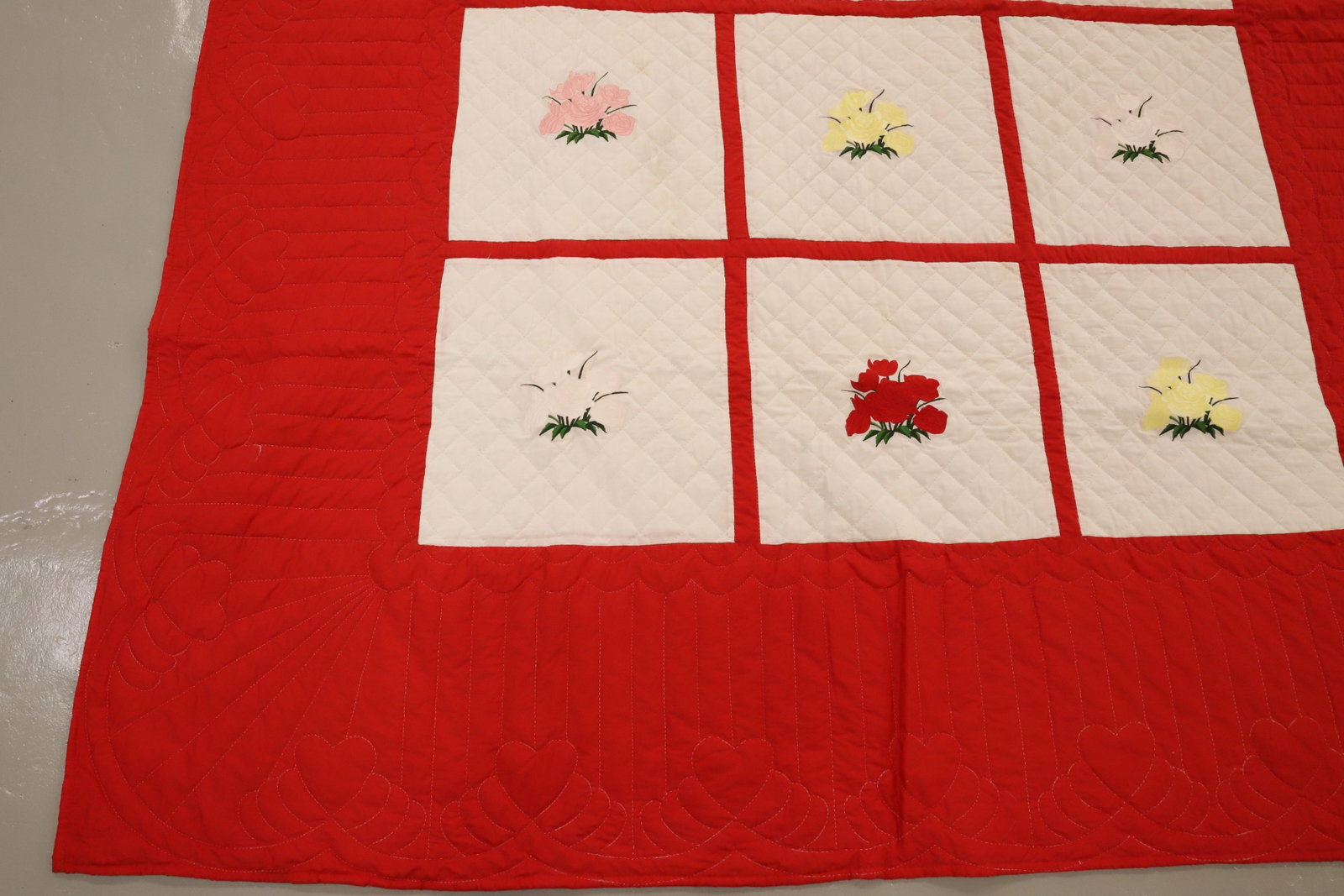 VINTAGE HAND STITCHED QUILT: RED/WHITE GRID WITH VARIOUS FLOWERS. 80" X 102". Terms: PLEASE READ CAREFULLY - Terms for Purchasing and Shipping of Auction Items. Please read carefully before bidding. All payments for purchases wil