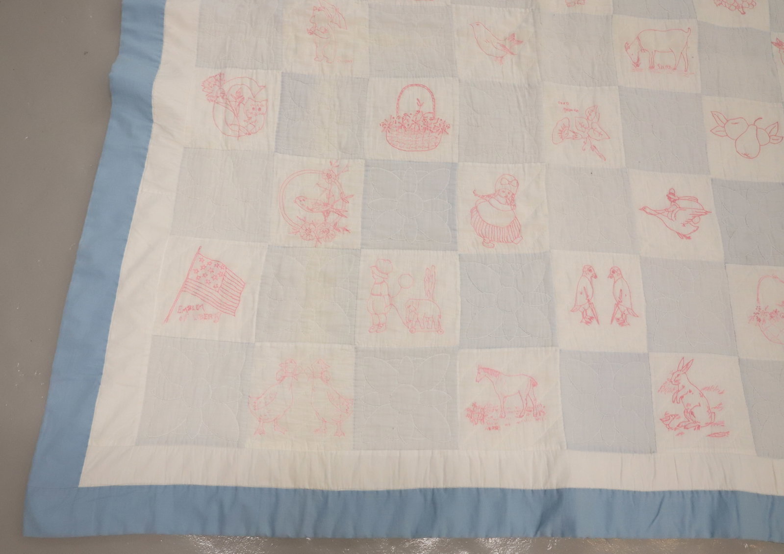 VINTAGE HAND STITCHED QUILT: BLUE/WHITE CHECK WITH STITCHED ANIMALS, PEOPLE, FLOWERS AND MORE. 62" X 66". Terms: PLEASE READ CAREFULLY - Terms for Purchasing and Shipping of Auction Items. Please read carefully before bidding. Al