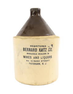 PATERSON, NJ STONEWARE ADVERTISING JUG: BERNARD KATZ CO. 11 1/2" H. Terms: PLEASE READ CAREFULLY BEFORE BIDDING. THIS SALE IS ONLINE AND IN-PERSON. PREVIEW WILL BE THURSDAY JANUARY 25TH FROM 9:00 AM TILL 4:00 PM AND FRIDAY JANUARY 26TH FROM