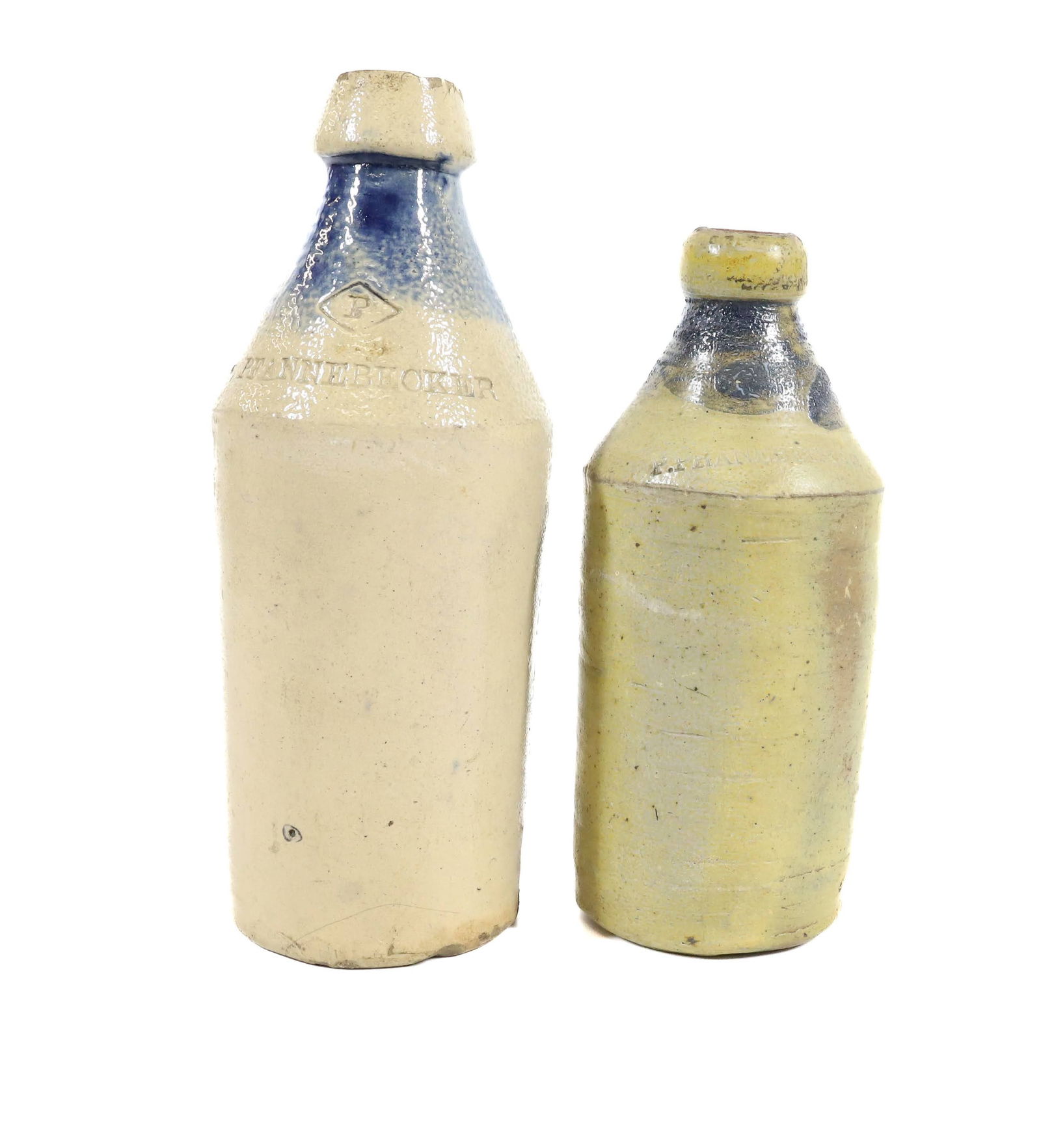 (2) STONEWARE ADVERTISING BOTTLES: BLUE DECORATION AT TOP. BOTH MRKD. P. PFANNEBECKER. 9" AND 10 3/4" H. PLEASE READ CAREFULLY - Terms for Purchasing and Shipping of Auction Items. Please read carefully before bidding. All payments for
