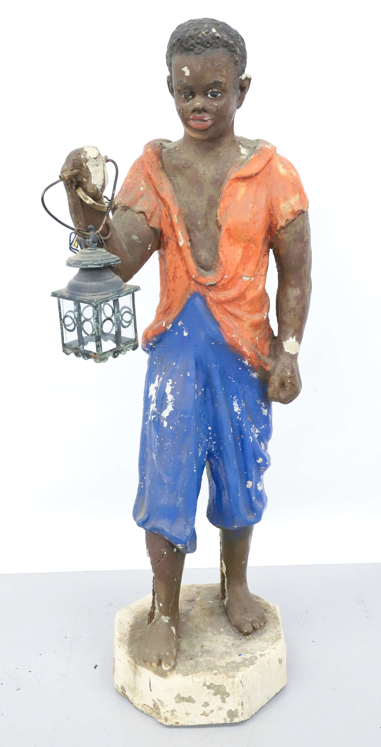 BLACK AMERICANA CAST GARDEN FIGURE: BOY HOLDING LANTERN. ORANGE AND BLUE PAINT. 48" WINNING BIDDER MUST SECURE SHIPPING. WE CAN NOT SHIP IN-HOUSE. DUE TO SIZE, WEIGHT AND FRAGILITY. PLEASE READ CAREFULLY - Terms for Purchasing and Shipp
