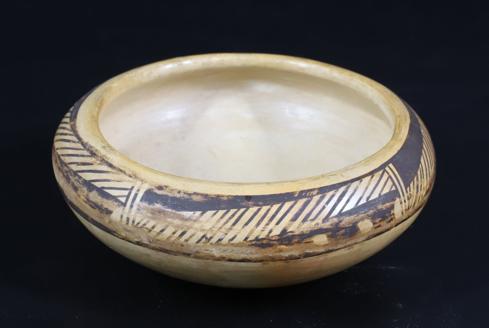 NATIVE AMERICAN POTTERY BOWL: POLYCHROME DECORATION AROUND TOP. SGND. ON BOTTOM. (ILLEGIBLE) 5" D.