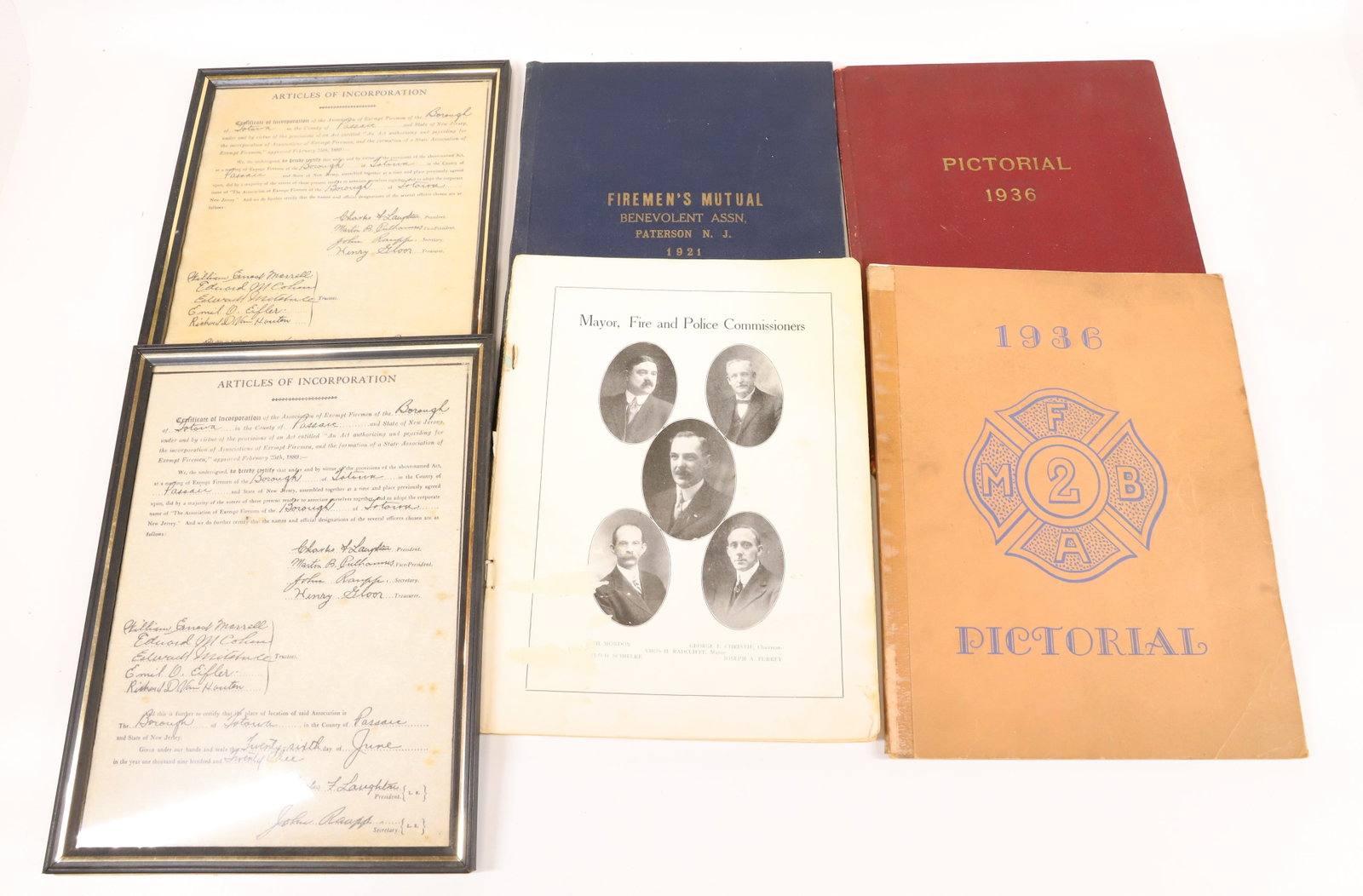 LOT OF FIRE COMPANY MEMORABILIA: INCLUDING: ARTICLES OF INCORPORATION OF THE ASSOCIATION OF EXEMPT FIREMEN OF TOTOWA IN PASSAIC COUNTY. 1923. BOOK OF MAYOR, FIRE AND POLICE COMMISSIONERS (PARTIAL), PICTORIAL 1936 OF PATERSON, AND FIR