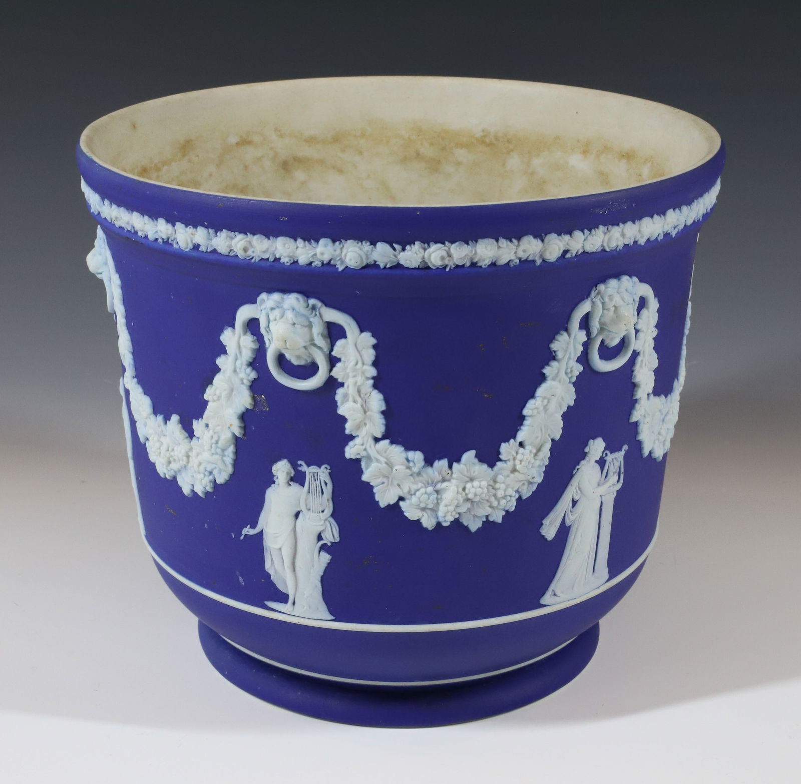 WEDGWOOD JASPERWARE: PORTLAND BLUE JASPERWARE JARDINIERE LION HEADS WITH DRAPING MARKED WEDGWOOD MADE IN ENGLAND 1930S 7" X 8" PLEASE READ CAREFULLY - Terms for Purchasing and Shipping of Auction Items. Please read carefu