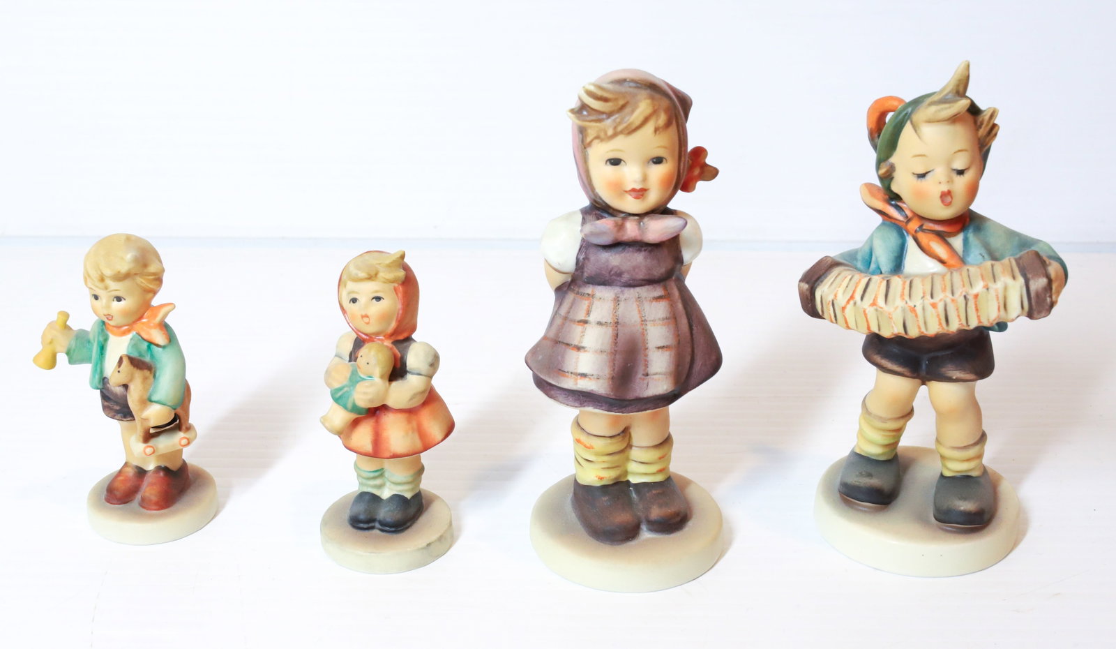 HUMMEL FIGURINES: ACCORDIAN 5 1/2 " H, WITCH HAN, GIRL WITH DOLL AND BOY WITH HORN. TMK-5 MARK PLEASE READ CAREFULLY - Terms for Purchasing and Shipping of Auction Items. Please read carefully before bidding. All payme