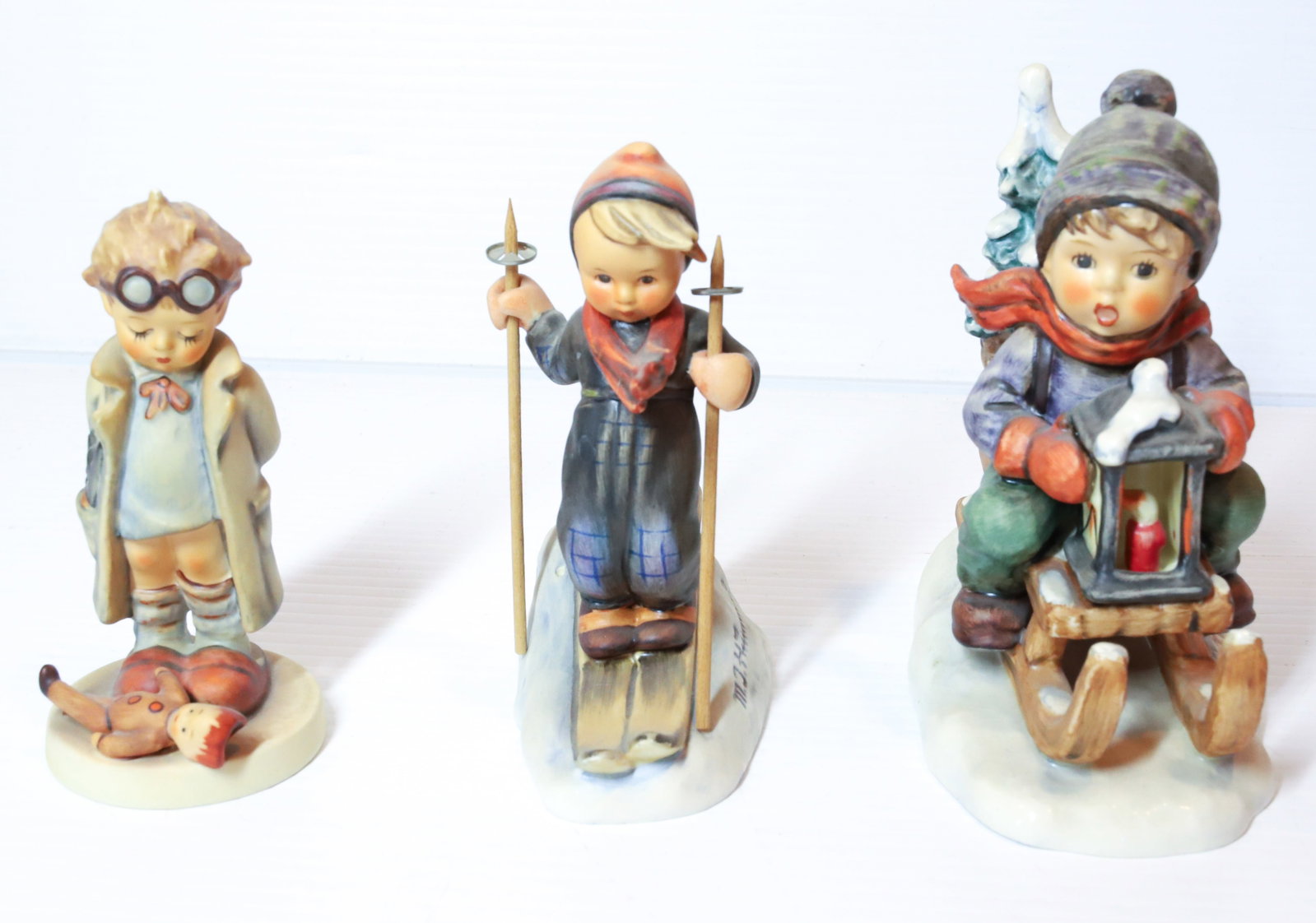 HUMMEL FIGURINES: RIDE INTO CHRISTMAS 5 1/2 " H, SKIER AND DOCTOR. TMK-5 MARKING PLEASE READ CAREFULLY - Terms for Purchasing and Shipping of Auction Items. Please read carefully before bidding. All payments for purcha