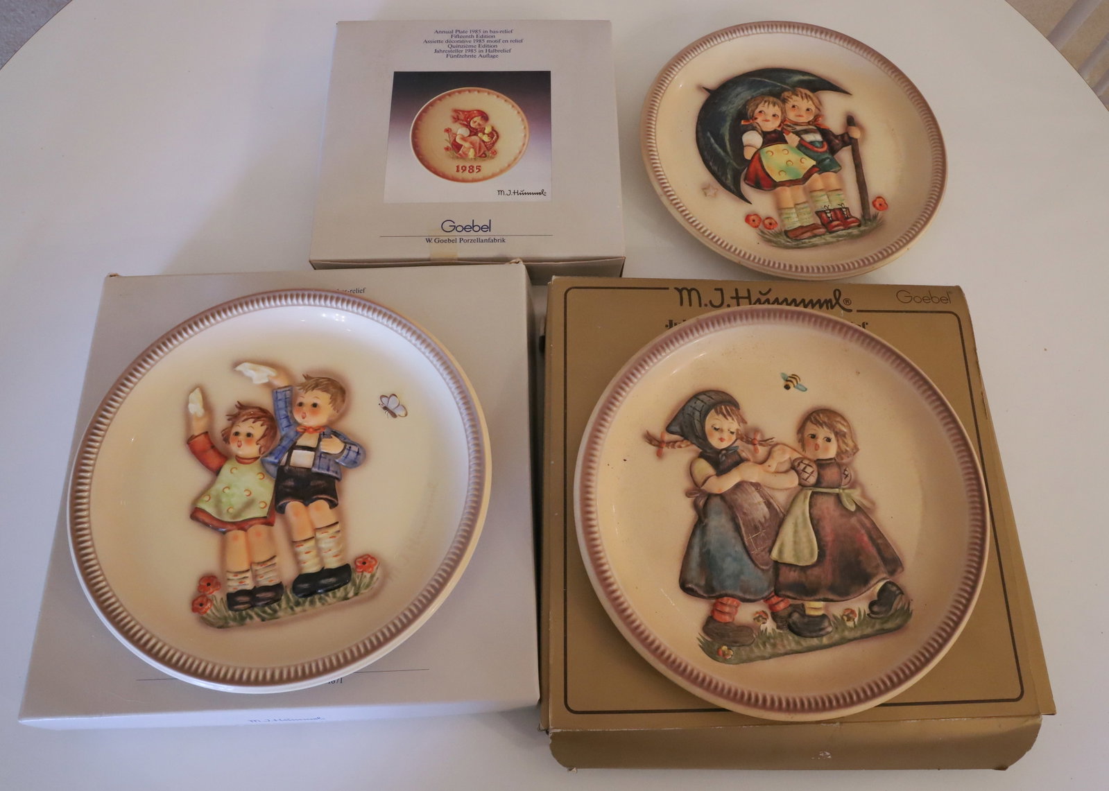 (4) HUMMEL PLATES: 1980, (2) 85 AND 19975 PLEASE READ CAREFULLY - Terms for Purchasing and Shipping of Auction Items. Please read carefully before bidding. All payments for purchases will be made through LiveAuctioneers
