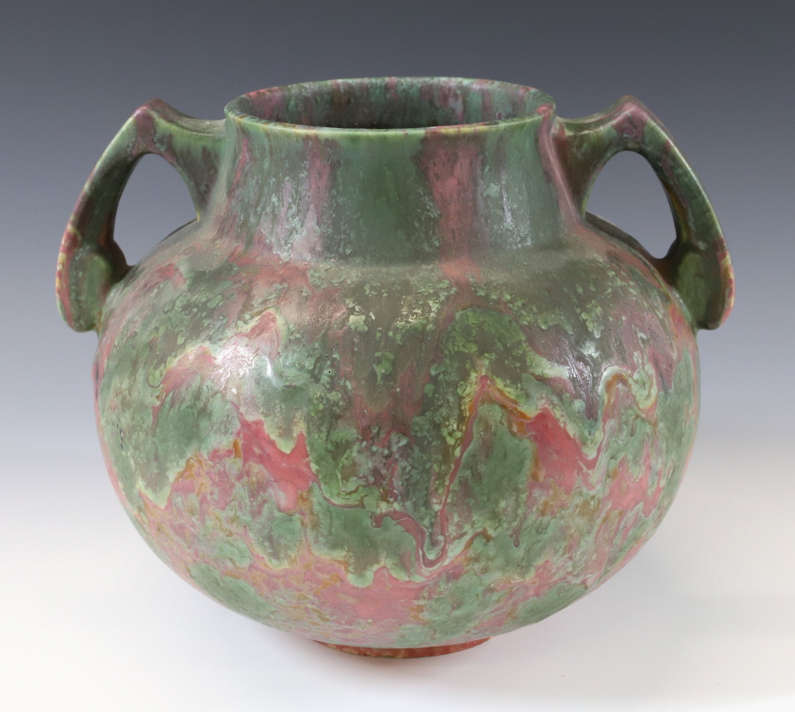 ROSEVILLE POTTERY CARNELIAN HANDLED VASE: STAMPED ON BOTTOM. NICE GLAZE. 8" X 9 1/2". PLEASE READ CAREFULLY - Terms for Purchasing and Shipping of Auction Items. Please read carefully before bidding. All payments for purchases will be made th