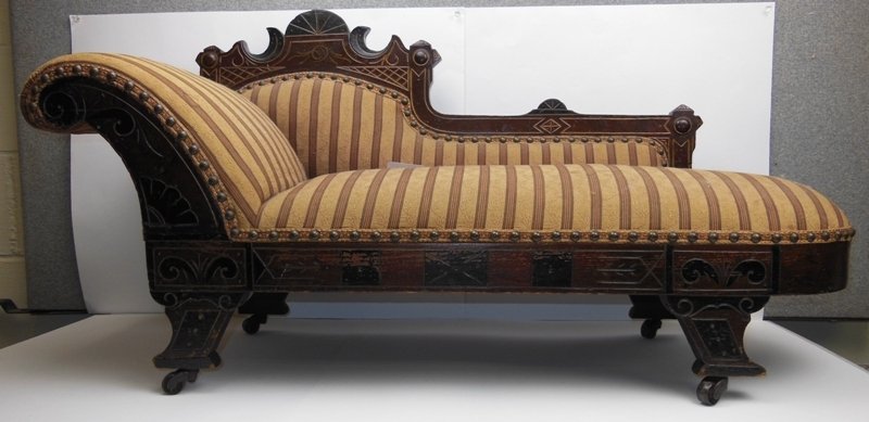 Unique Eastlake Child's Divan. (salesman sample fai: 21 1/2" high x 42" long. Original finish with black & gold highlights. Light stain on fabric. Over all in good condition.