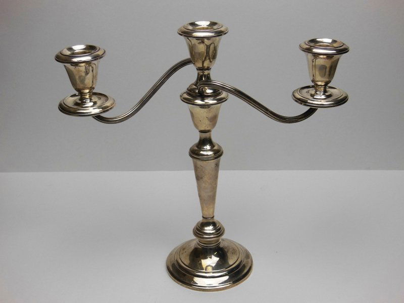 Gorham Sterling Silver 3 arm candelabra.: Gorham Sterling Silver 3 arm candelabra. Weighted. With original paper label. 11 1/2" tall. Overall condition is Good. Small bend to one bobeche.