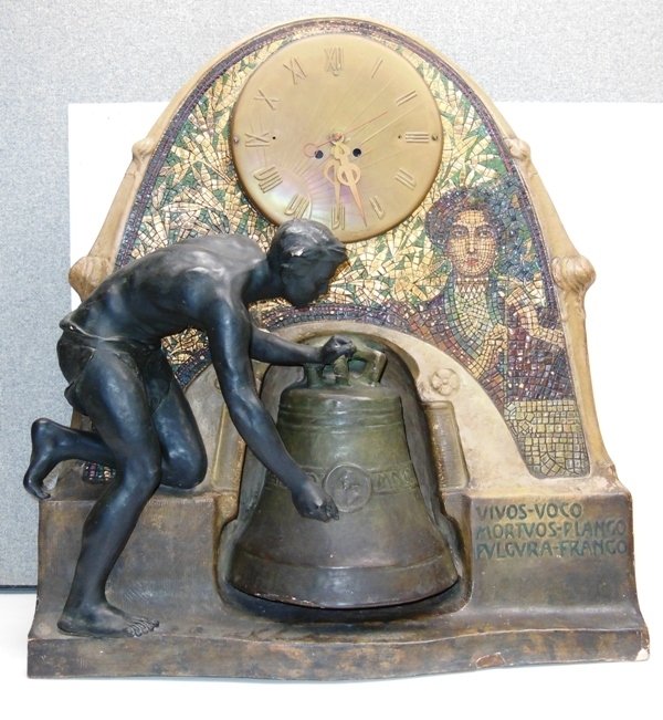 Unusual Figural Clock Arts & Craft Style: plaster case clock. 25" x 22 1/2". Bell & bell ringer. Inscription in latin "I call the living; I toll for the dead; I distroy the lightening" Germany. Electric movement.