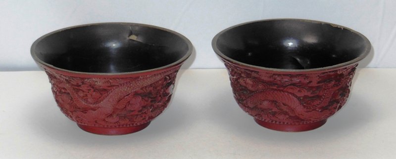 Early Carved Cinnabar Bowls: (2) 6 1/2" x 3 1/4" carved dragon and flower motif. 1 with background loss (3/4" dia.). Reign mark on base.