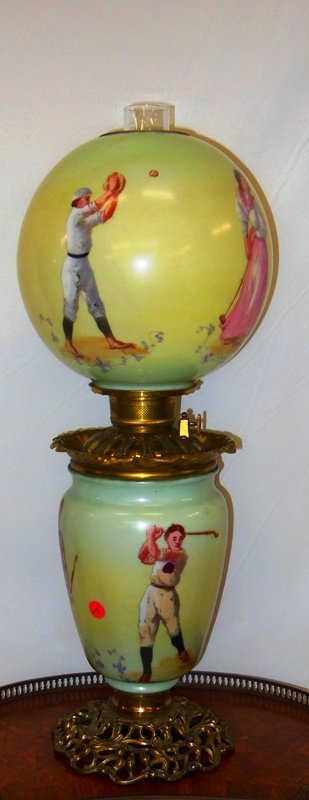 19th Century Gone with the Wind Lamp with Sporting: 25" x 10" Original Condition. (Not Electrified) Soccer, Rugby, Baseball, Croquet and other sports represented. Burner marked made in USA.