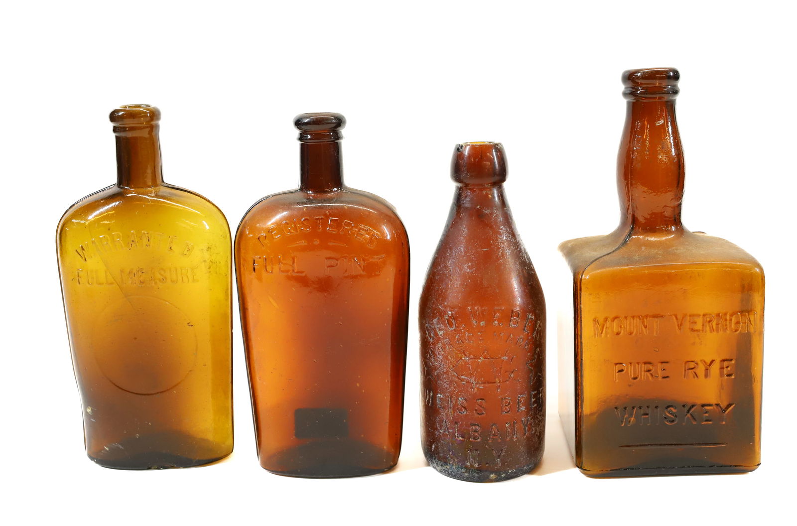 LOT OF AMBER BOTTLES: MOUNT VERNON PURE RYE WHISKEY 8 1/2" H., (2) FULL PINT FLASKS AND "WEBER, ALBANY, NY" BOTTLE. PLEASE READ CAREFULLY - Terms for Purchasing and Shipping of Auction Items. Please read carefully before b