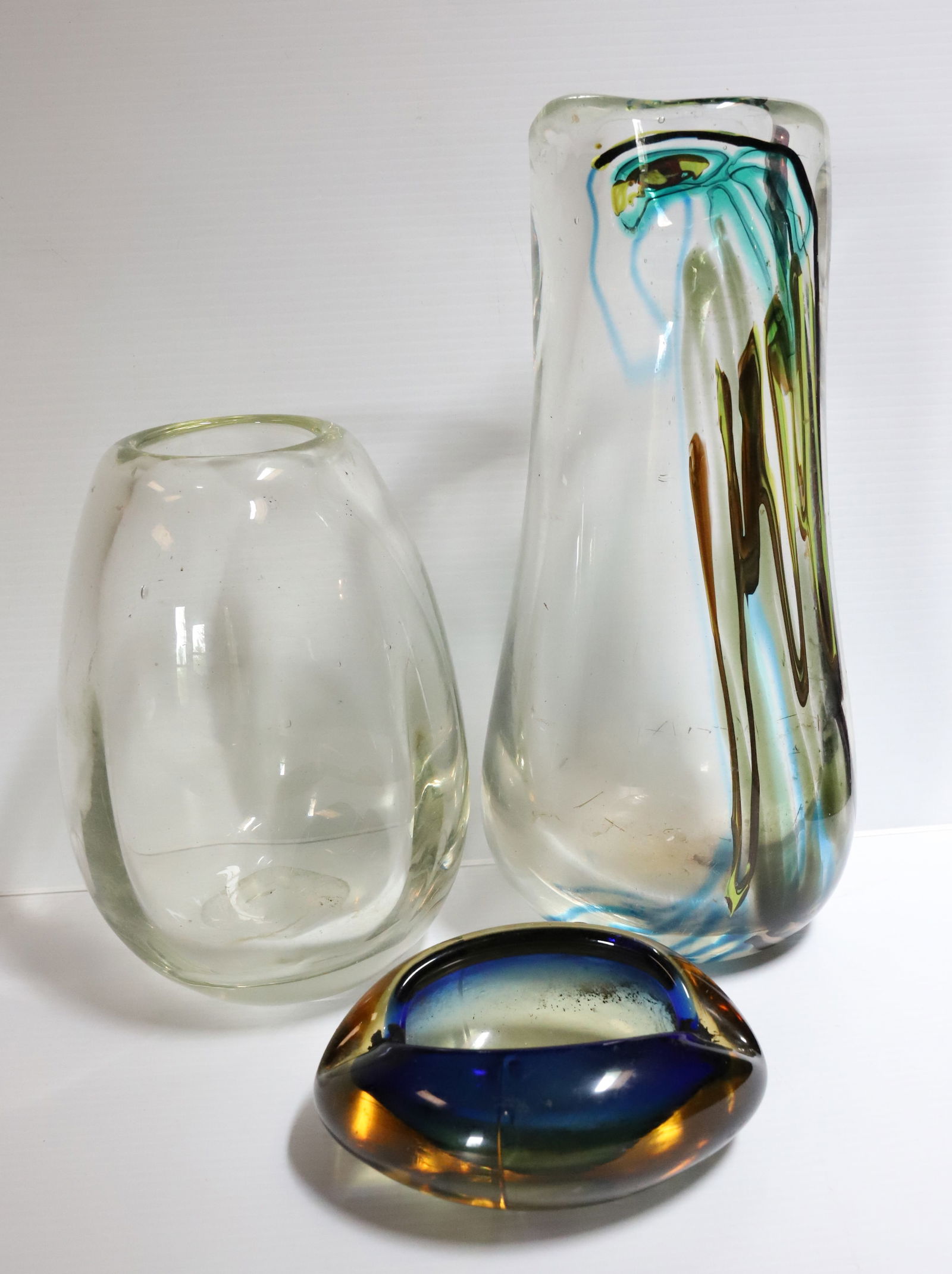 LOT OF ART GLASS: INCLUDING: HEAVY BLOWN GLASS VASE WITH COLORED STRIATIONS 14 3/4" H., CLEAR BLOWN GLASS VASE 10" H. AND ASHTRAY. PLEASE READ CAREFULLY – THIS IS AN ONLINE ONLY AND ONSITE AUCTION. THE ADDRESS WI