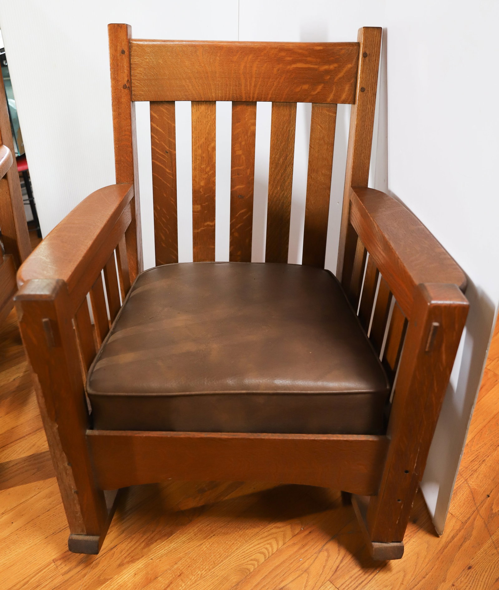 HARDEN ARTS AND CRAFT ROCKING CHAIR: MISSION OAK WITH DROP IN SEAT. MORTISED AND PEGGED CONSTRUCTION. 35 1/2" X 28 1/2" X 21". PLEASE READ CAREFULLY – THIS IS AN ONLINE ONLY AND ONSITE AUCTION. THE ADDRESS WILL BE GIVEN AFTER THE A