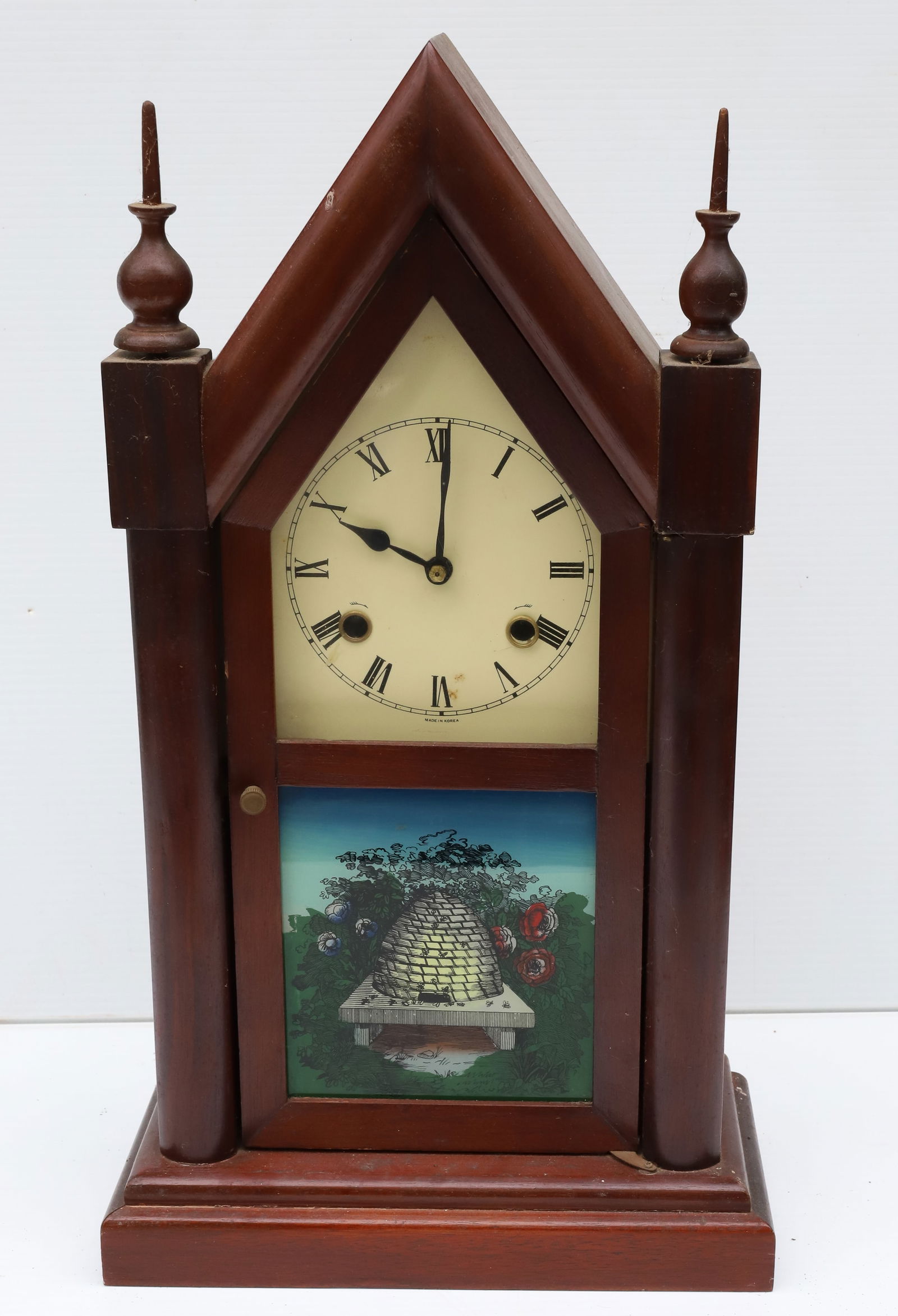 CONTEMPORARY STEEPLE CLOCK: REVERSE PAINTED FRONT. MRKD. MADE IN KOREA ON FACE AND ON BACK. 20 1/2" H. PLEASE READ CAREFULLY – THIS IS AN ONLINE ONLY AND ONSITE AUCTION. THE ADDRESS WILL BE GIVEN AFTER THE AUCTION HAS ENDE