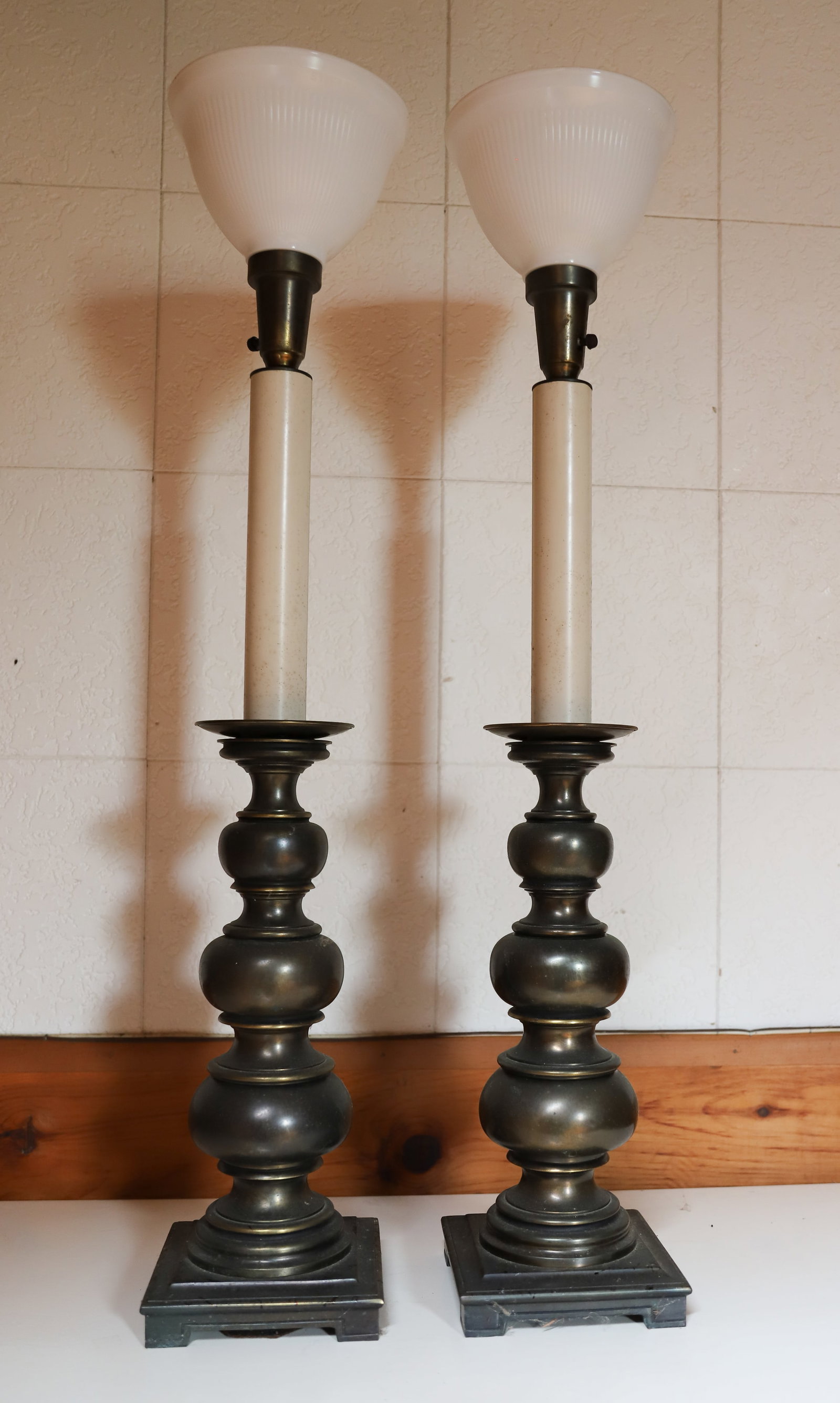 (2) VINTAGE TABLE LAMPS: METAL OR BRASS BASES WITH MILK GLASS TOPPERS. 39" H. PLEASE READ CAREFULLY – THIS IS AN ONLINE ONLY AND ONSITE AUCTION. THE ADDRESS WILL BE GIVEN AFTER THE AUCTION HAS ENDED AND TO ALL SUCCESSFU