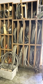 LARGE LOT OF METAL STORAGE CABINETS WITH HOSES