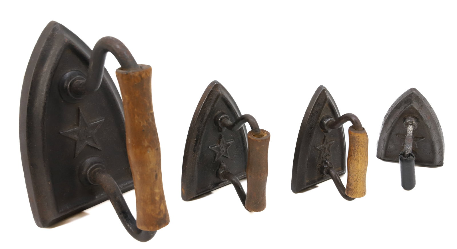 (4) GRADUATED FLAT IRONS: FOUR FLAT IRONS WITH WOODEN GRIPS, EMBOSSED STARS AND NUMBERS 14,8, 7 AND 7. 2 15/16 TO 5" LENGTHS. TERMS: PLEASE READ CAREFULLY - Terms for Purchasing and Shipping of Auction Items. Please read caref