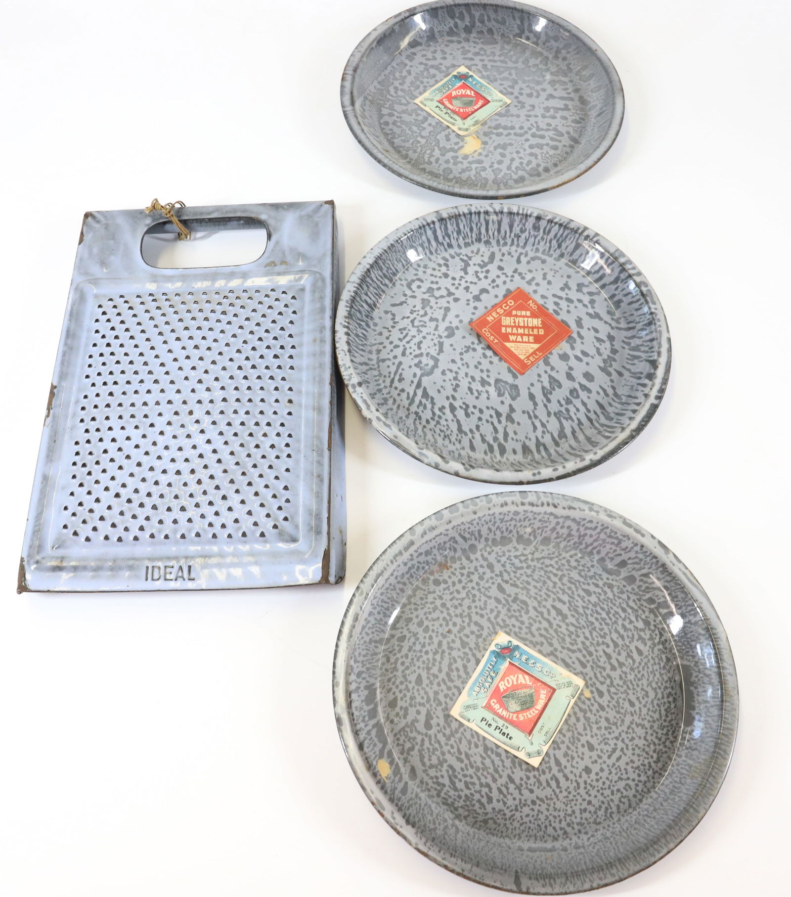 AGATEWARE GRATER AND PIE PLATES, ORIGINAL LABELS: GRAY "IDEAL" GRATER AND THREE PIE PLATES WITH PAPER LABELS 9" D. TERMS: PLEASE READ CAREFULLY - Terms for Purchasing and Shipping of Auction Items. Please read carefully before bidding. All payments f