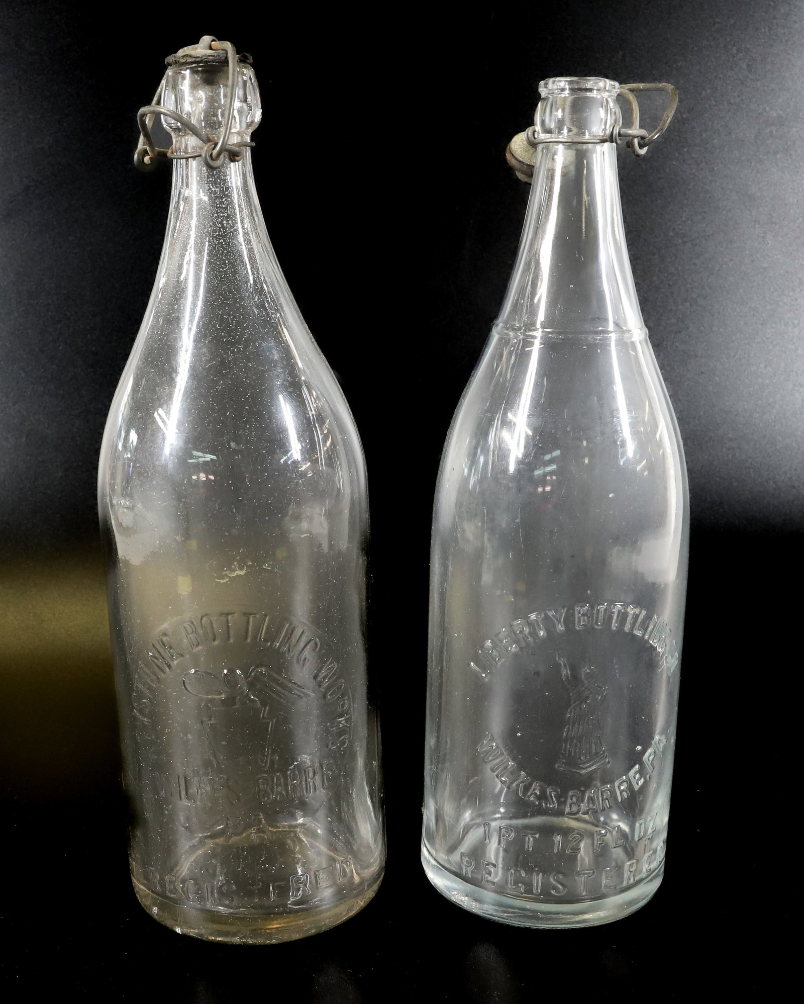 (2) WILKES-BARRE, PA BOTTLES: KEYSTONE BOTTLING WORKS WITH EAGLE/KEYSTONE AND LIBERTY BOTTLING CO. WITH STATUE OF LIBERTY. 11" AND 11 1/4" HEIGHTS. TERMS: PLEASE READ CAREFULLY - Terms for Purchasing and Shipping of Auction Items.