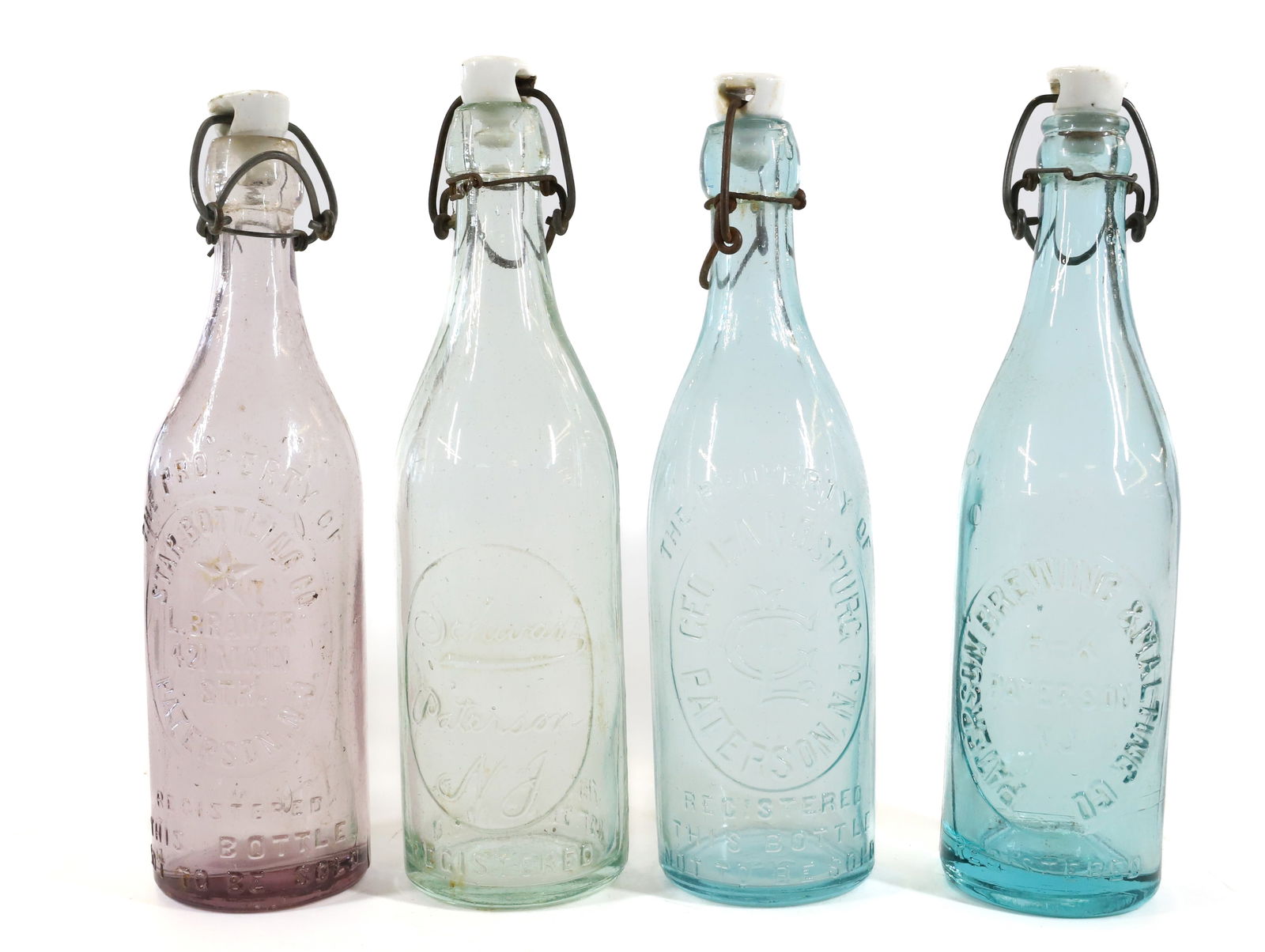 (4) PATERSON, NJ BOTTLES W/STOPPERS (1 of 5)
