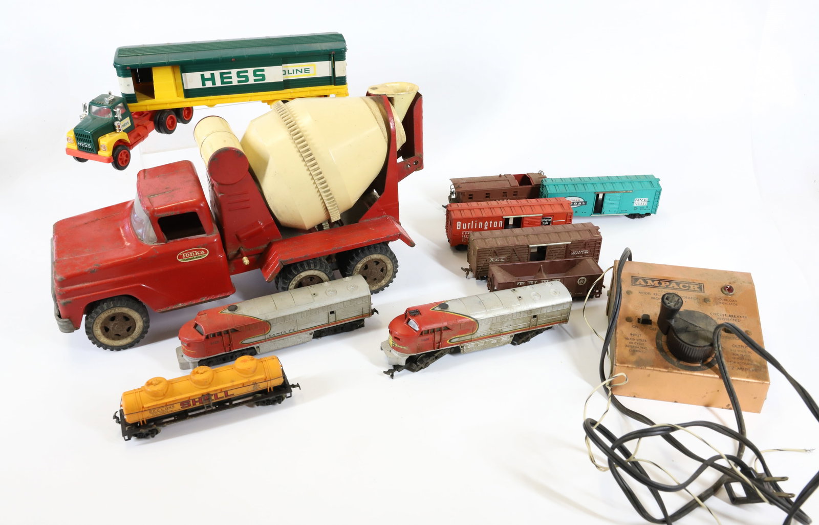 LOT OF TRUCKS AND TRAINS: INCLUDING: TONKA PRESSED STEEL/PLASTIC CEMENT MIXER 14" L., AHM HO-GAUGE TRAIN WITH TRANSFORMER AND HESS TRUCK. TERMS: PLEASE READ CAREFULLY - Terms for Purchasing and Shipping of Auction Items. Pleas