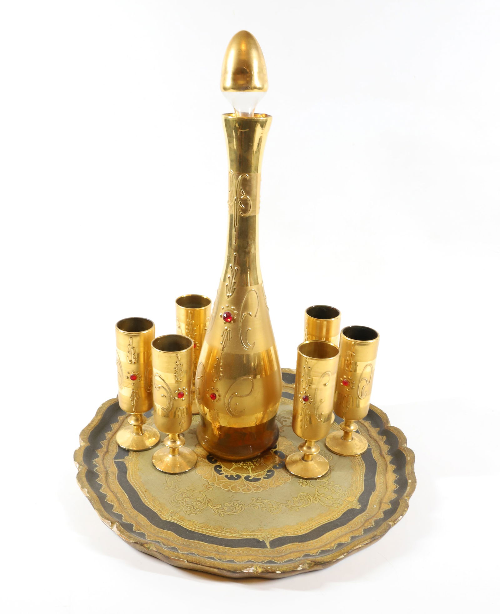 LIQUOR SET (8): GOLD PLATED GLASS WITH APPLIED JEWELS 1950S WITH ITALIAN PAPER MACHE TRAY 16 1/2"H, 5 1/2"H, 14" DIA PLEASE READ CAREFULLY – THIS IS AN ONSITE ONLINE ONLY AUCTION. The Address is 206 Market St.