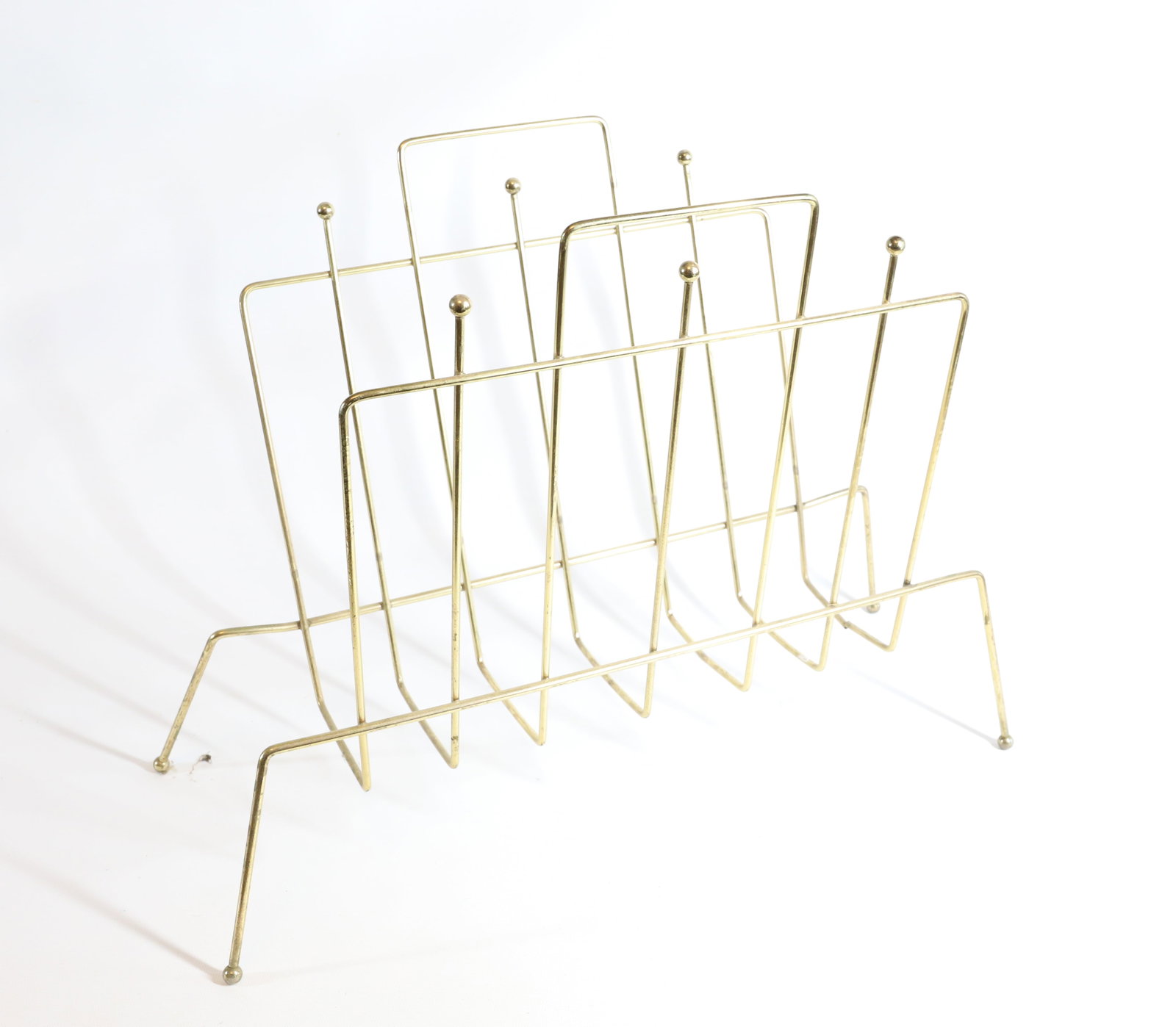 MID CENTURY MAGAZINE RACK: GOLD COLORED METAL 14 1/2" X 17" PLEASE READ CAREFULLY – THIS IS AN ONSITE ONLINE ONLY AUCTION. The Address is 206 Market St. Bangor, Pa. 18013