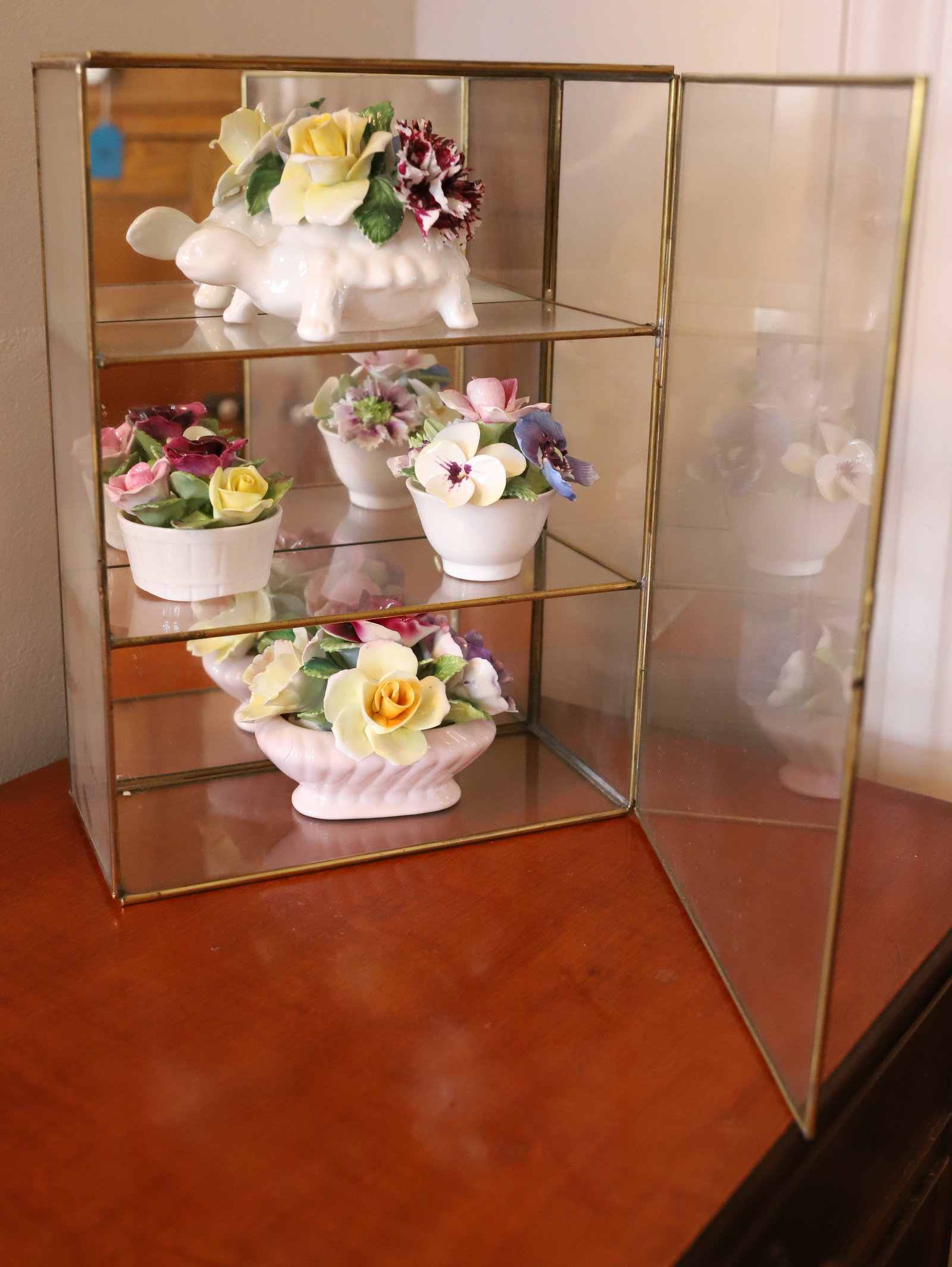 STAFFORDSHIRE CHINA FLOWERS: (4) POTS OF PORCELAIN FLOWERS WITH BRASS FRAME WALL/TABLE CASE TWO SHELVES 11" X 8" X 4" PLEASE READ CAREFULLY – THIS IS AN ONSITE ONLINE ONLY AUCTION. The Address is 206 Market St. Bangor, Pa. 