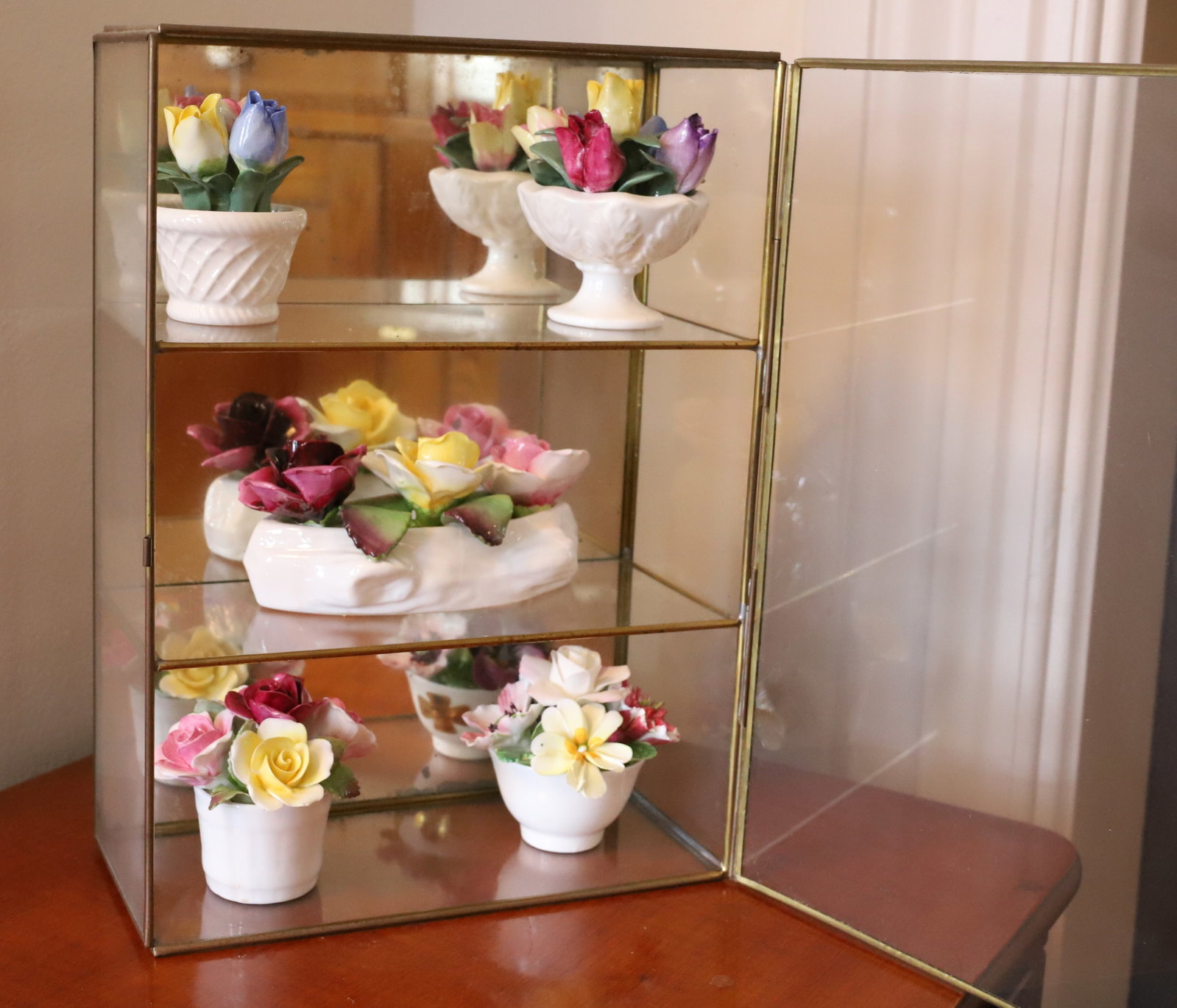 STAFFORDSHIRE CHINA FLOWERS: (5) POTS OF PORCELAIN FLOWERS WITH BRASS FRAME WALL/TABLE CASE TWO SHELVES 11" X 8" X 4" PLEASE READ CAREFULLY – THIS IS AN ONSITE ONLINE ONLY AUCTION. The Address is 206 Market St. Bangor, Pa. 