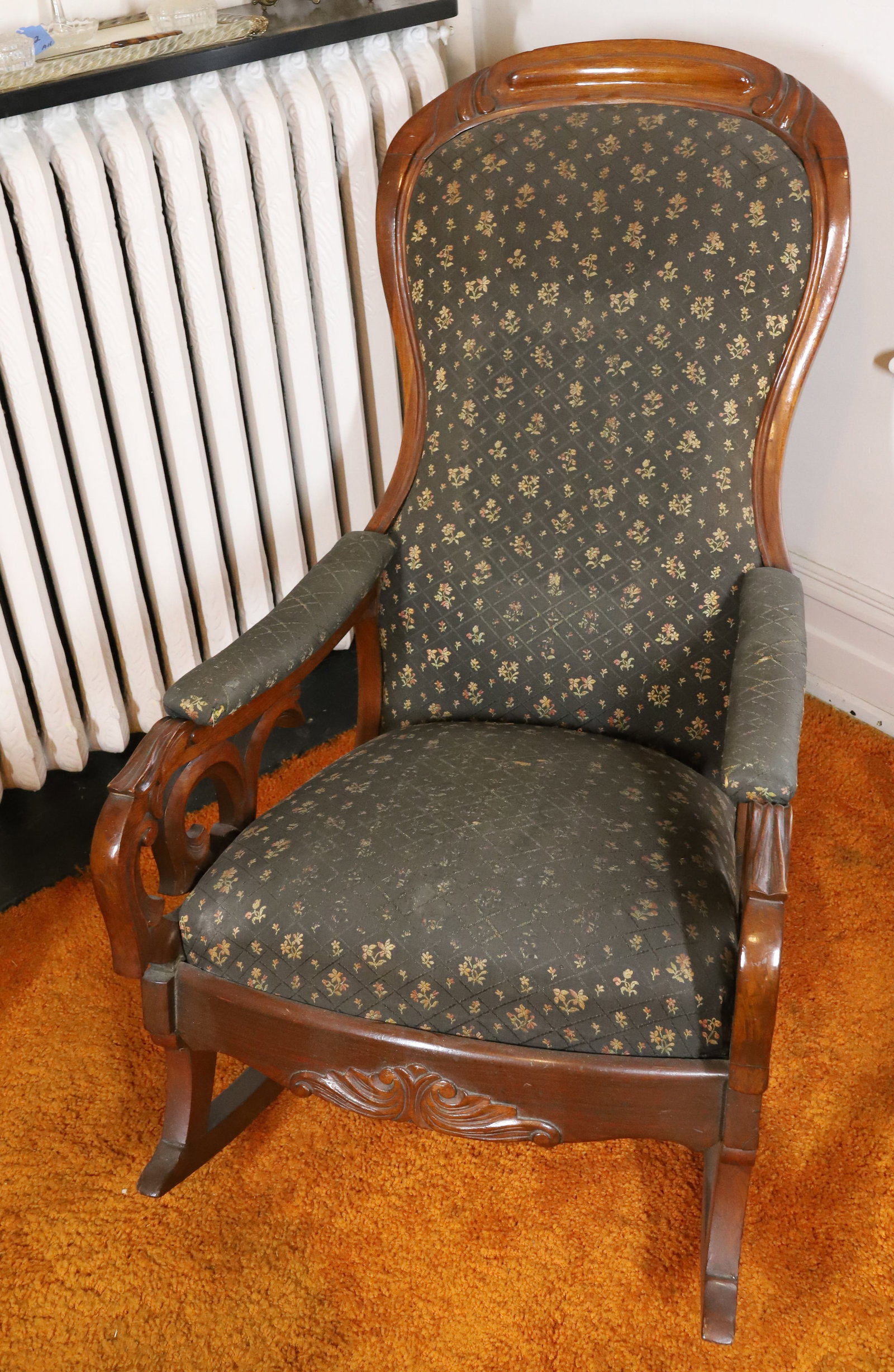 VICTORIAN WALNUT WOOD ROCKER: UPHOLSTERED WITH ARMS ALSO BACK SUPPORT FOR READING 38" X 23"W X 36" PLEASE READ CAREFULLY – THIS IS AN ONSITE ONLINE ONLY AUCTION. The Address is 206 Market St. Bangor, Pa. 18013