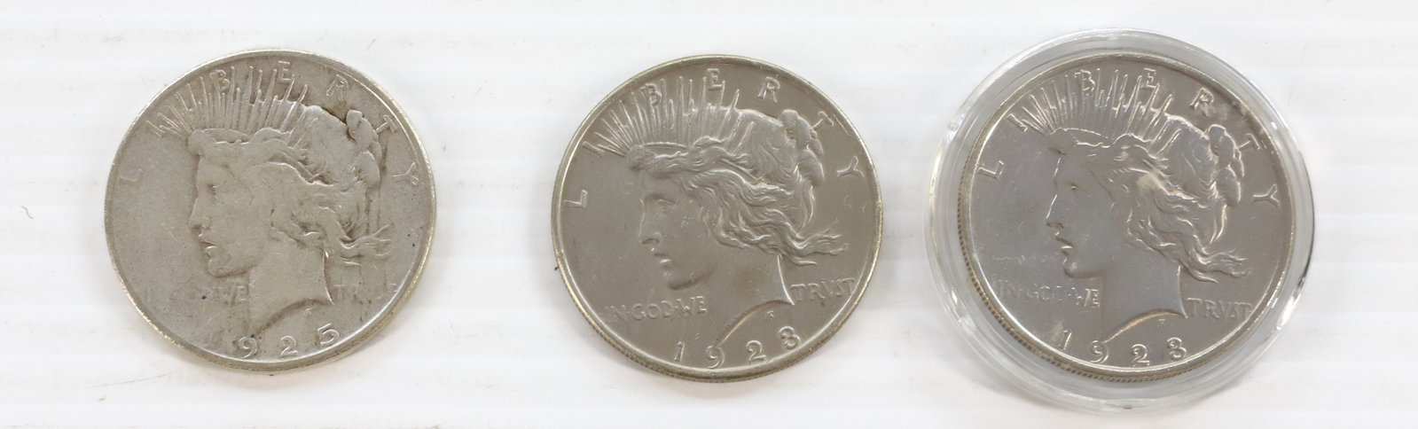 PEACE DOLLAR LOT: 1928, 1925 S, AND 1923 PLEASE READ CAREFULLY BEFORE BIDDING. ALL PURCHASES OF GOLD OR SILVER VIA LIVE AUCTIONEERS MUST BE PAID FOR THROUGH THE LIVE AUCTIONEERS PAYMENT PROCESSING CENTER. NO IN-HOUSE C